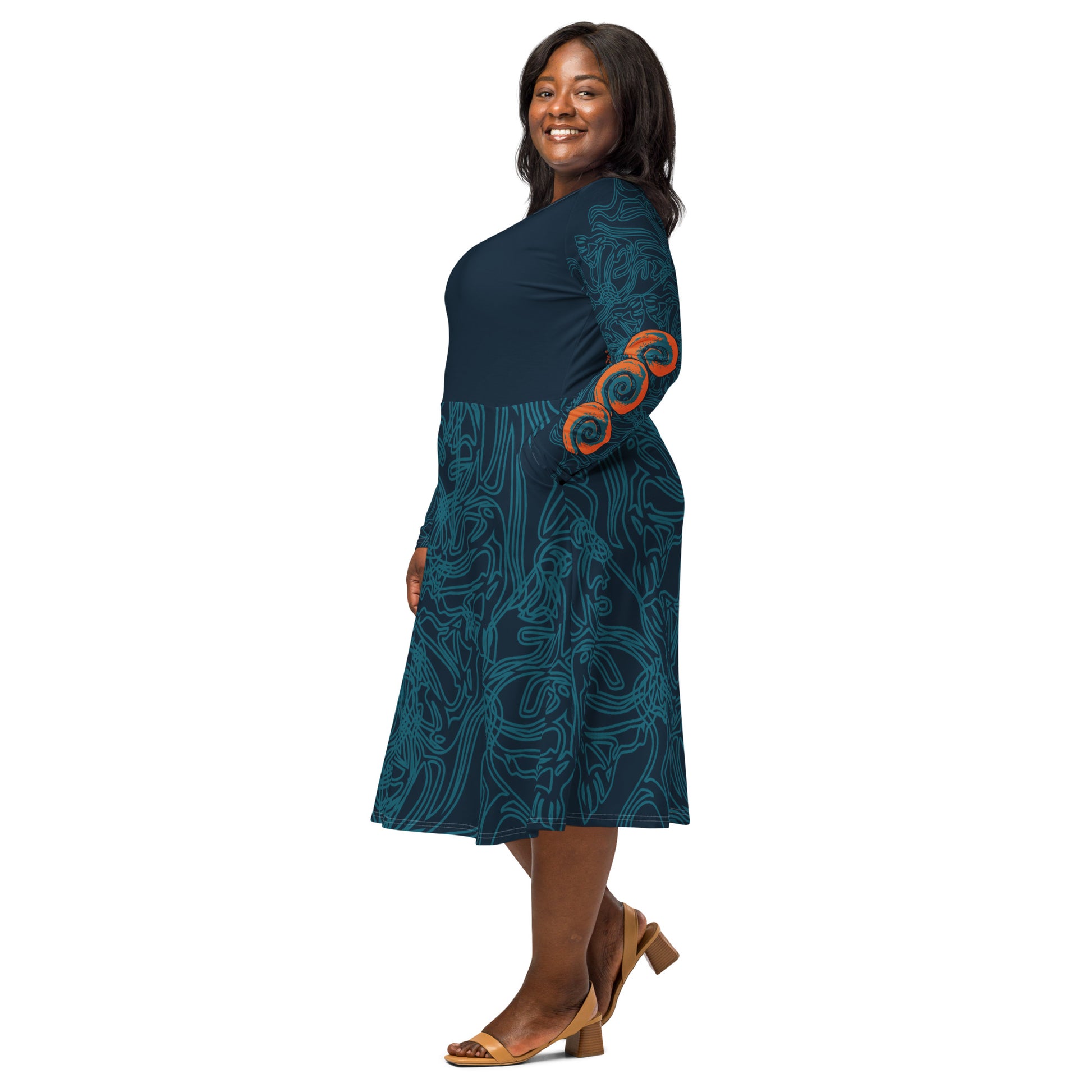 Side view of a navy blue long-sleeve dress with swirling cyan line art, bold orange sleeve accents, and a fit-and-flare design, on a model. 