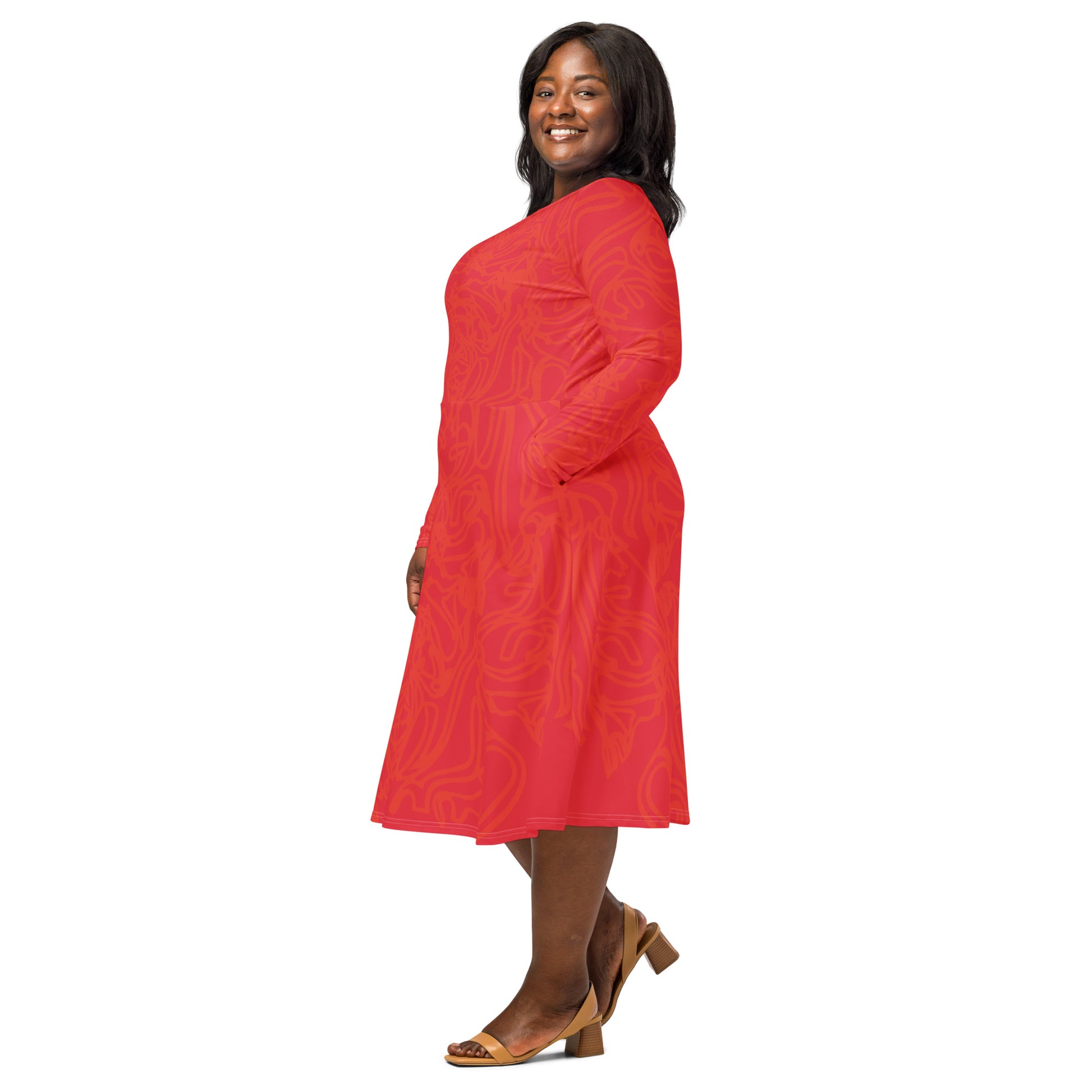 Red dress with vibrant swirl  details and mirrored face design on the back, inspired by cultural art and bold self-expression.