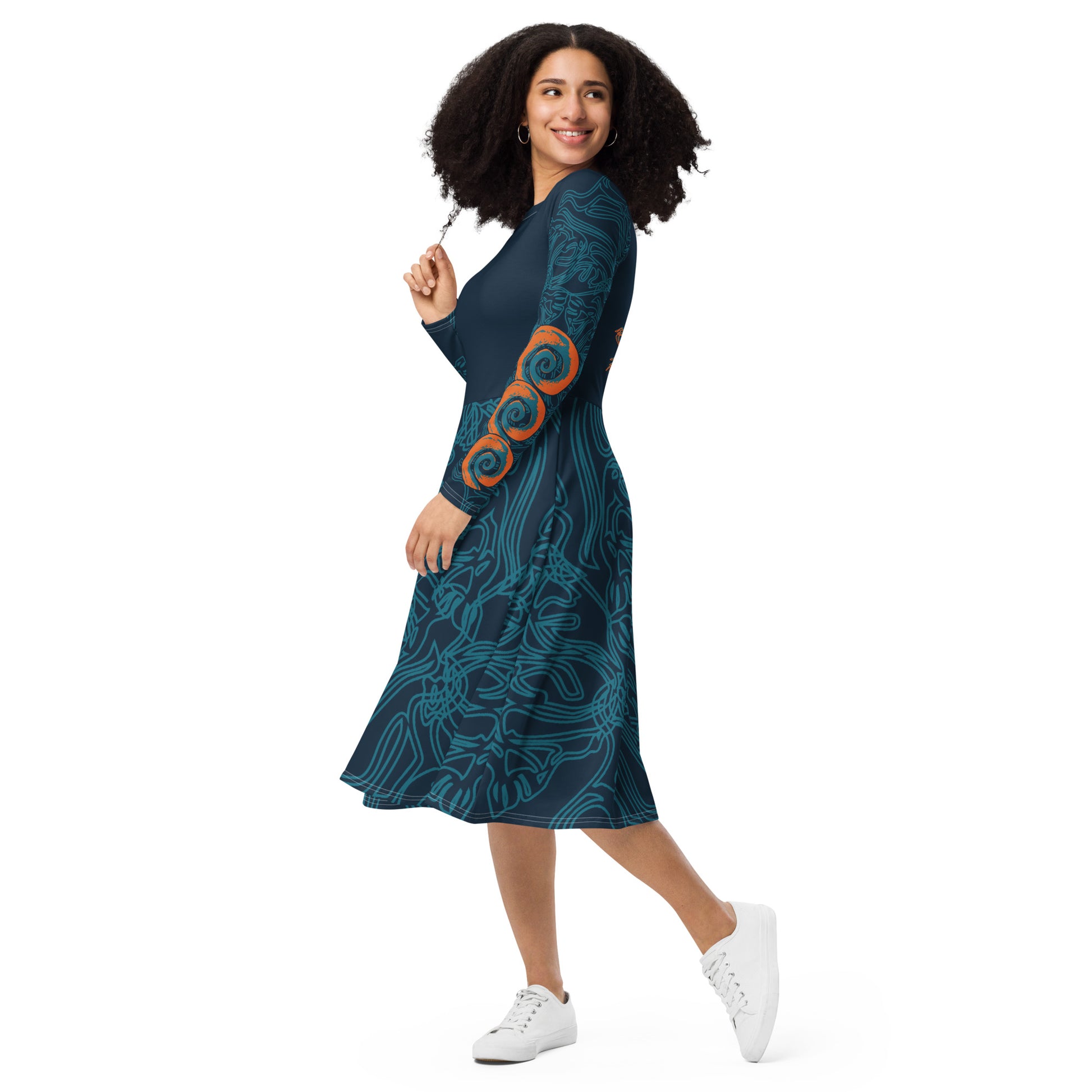 Side view of a navy blue long-sleeve dress with swirling cyan line art, bold orange sleeve accents, and a fit-and-flare design, on a model. 