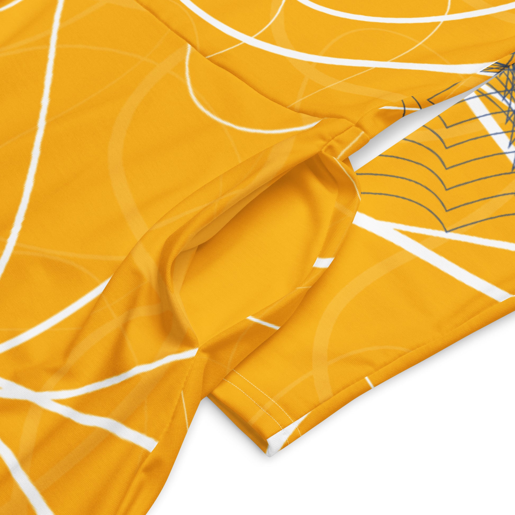 Front view of a golden yellow long sleeve midi dress featuring white swirling line art and navy geometric accents, blending flowing streetwear design with expressive hand-drawn patterns, showing pocket details.