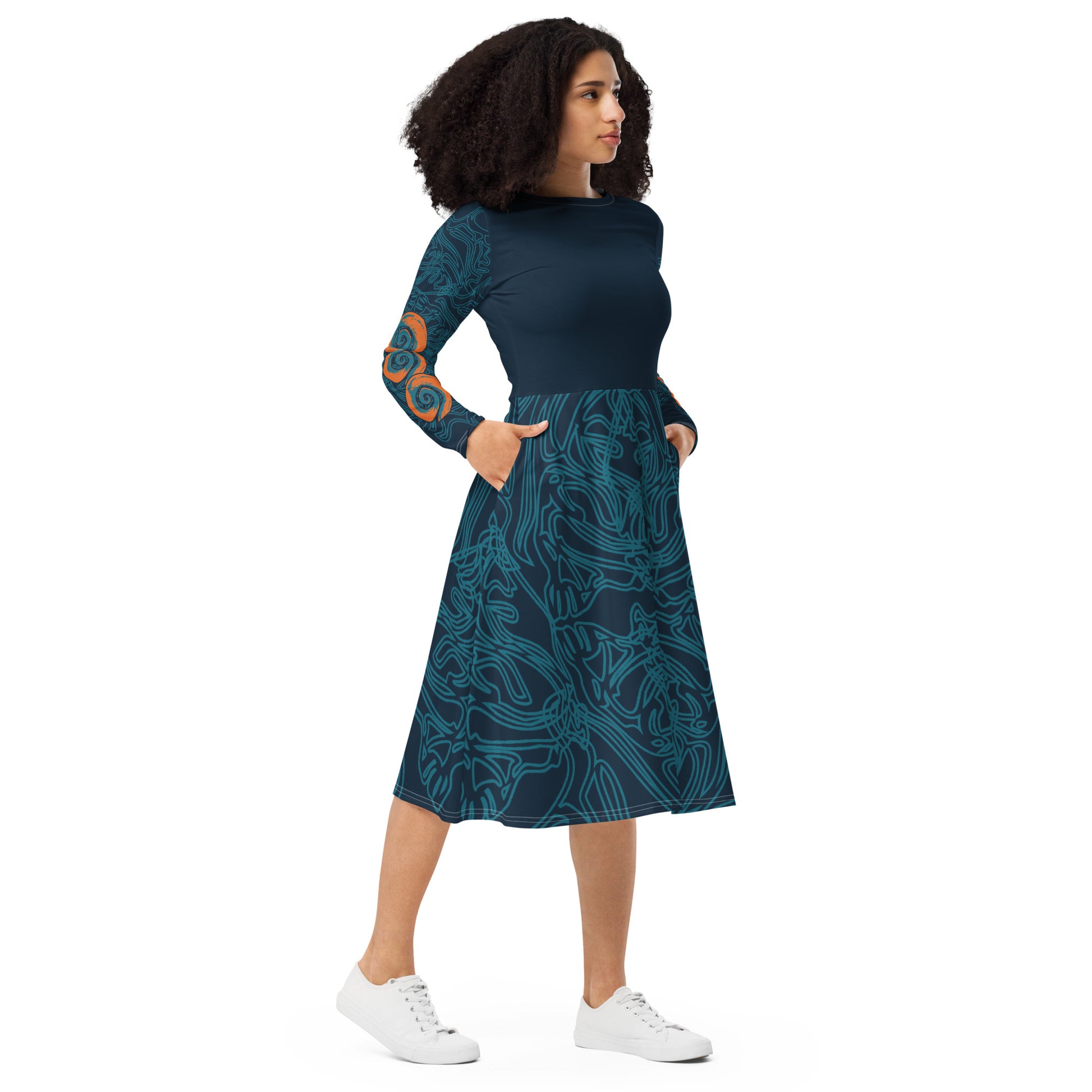 Front view of a navy blue long-sleeve dress with swirling cyan line art, bold orange sleeve accents, and a fit-and-flare design, on a model. 