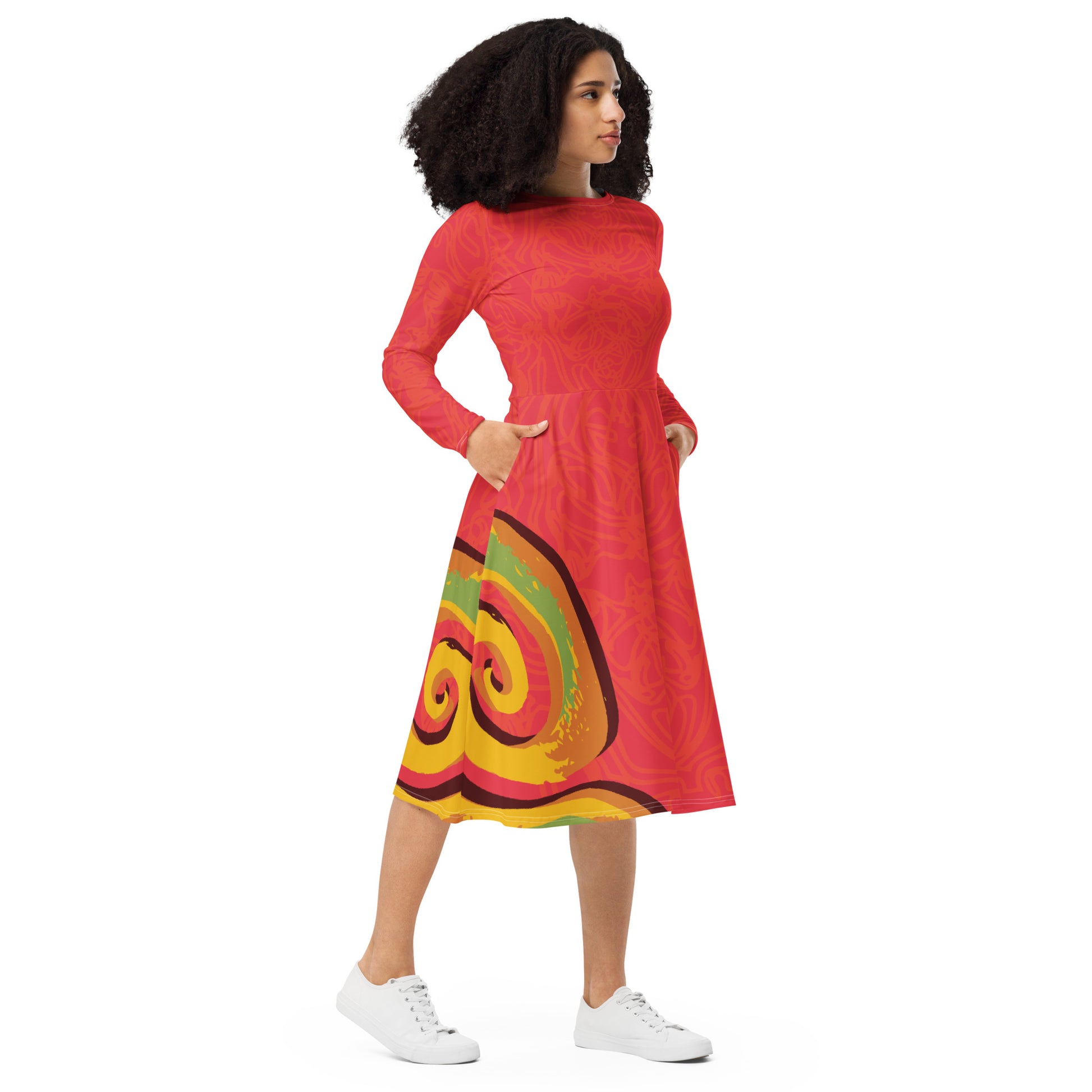 Red dress with vibrant swirl  details and mirrored face design on the back, inspired by cultural art and bold self-expression.