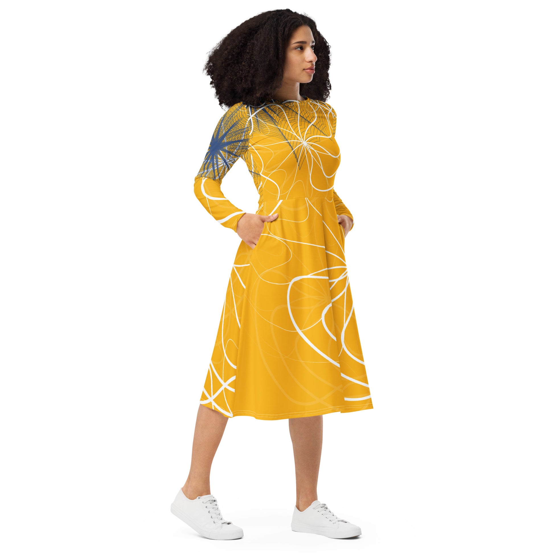 Front view of a golden yellow long sleeve midi dress featuring white swirling line art and navy geometric accents, blending flowing streetwear design with expressive hand-drawn patterns.