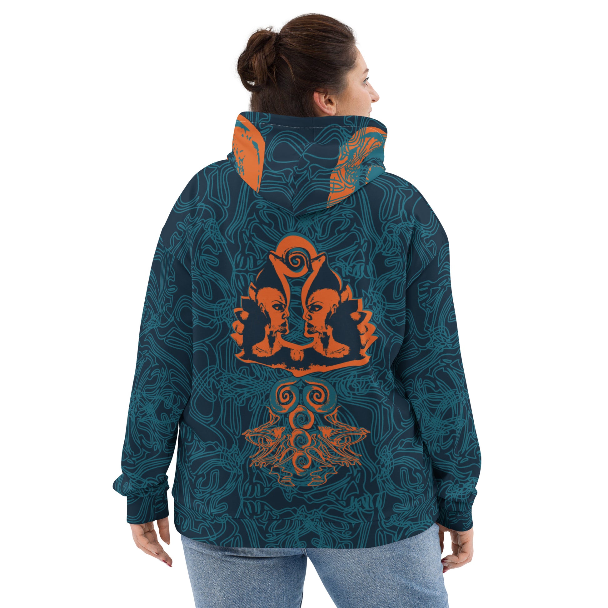 Back view of a navy blue hoodie featuring intricate cyan patterns and bold orange mirrored faces, with a tribal-inspired design on the hood.