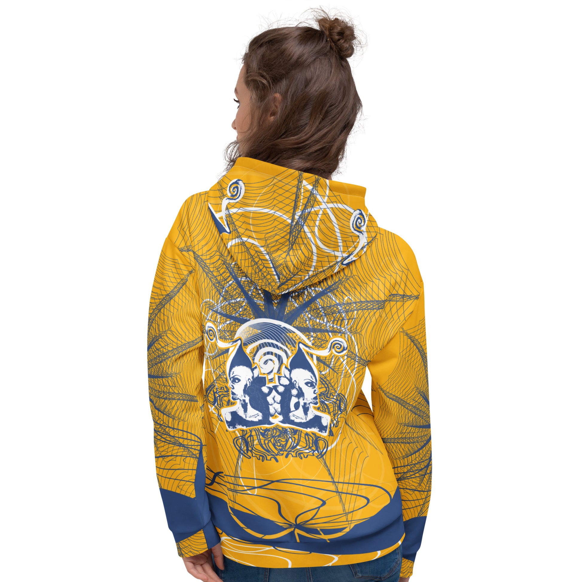Back view of a golden yellow hoodie with layered navy linework and a mirrored face emblem at the center, combining cultural symbolism with modern streetwear design from the Secret Chambers of I and I collection.