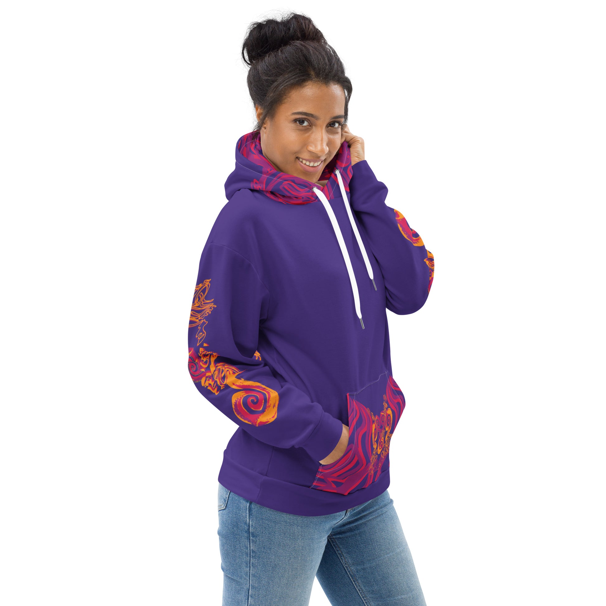 A model wearing a vibrant purple hoodie with bold orange and red culturally inspired patterns, mirrored face design, and abstract swirls — expressive fashion from KLOE’s The Secret Chambers of I & I collection.