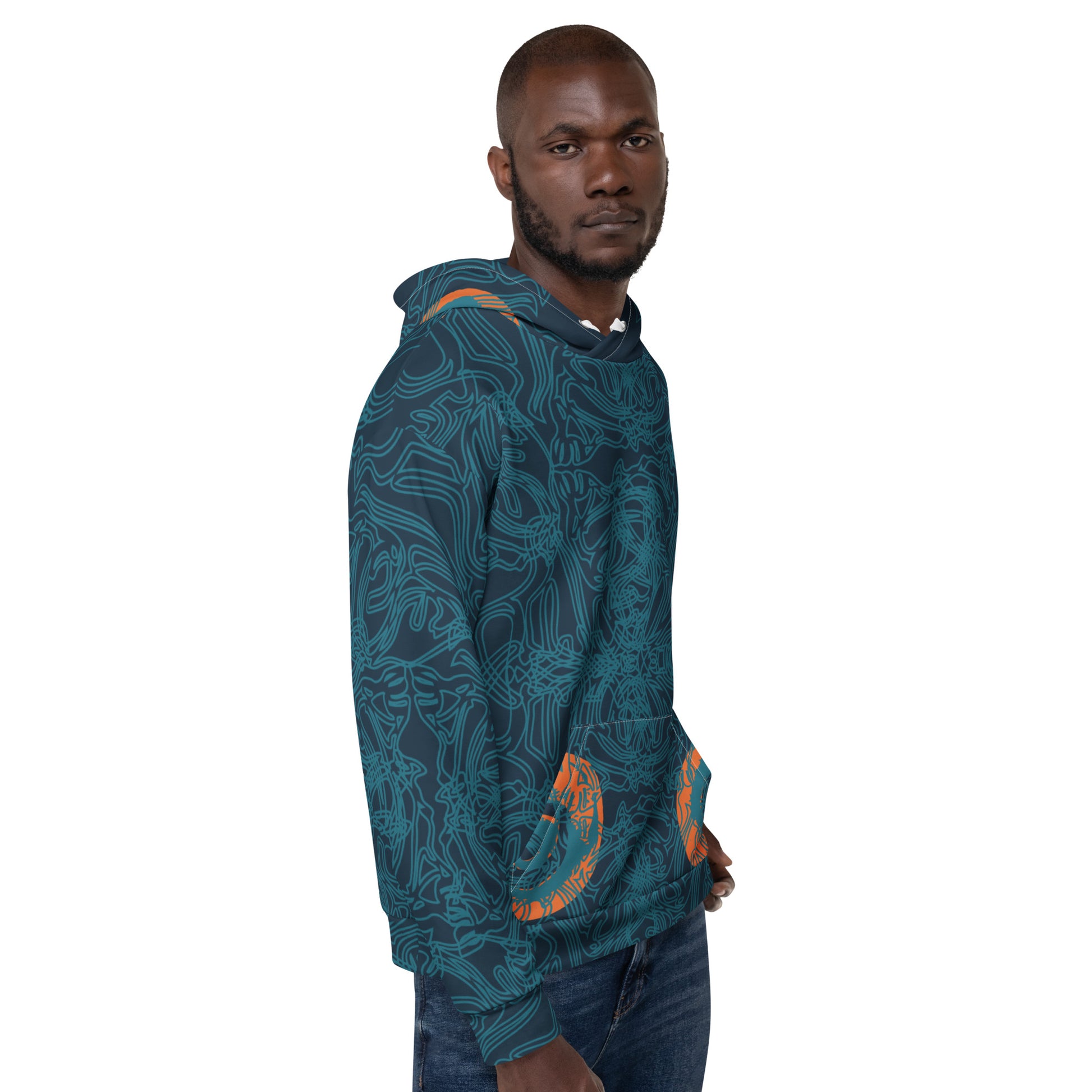 Side front view of a navy blue hoodie with intricate cyan linework, subtle orange tribal accents on the pockets, and a spacious hood, on a model.