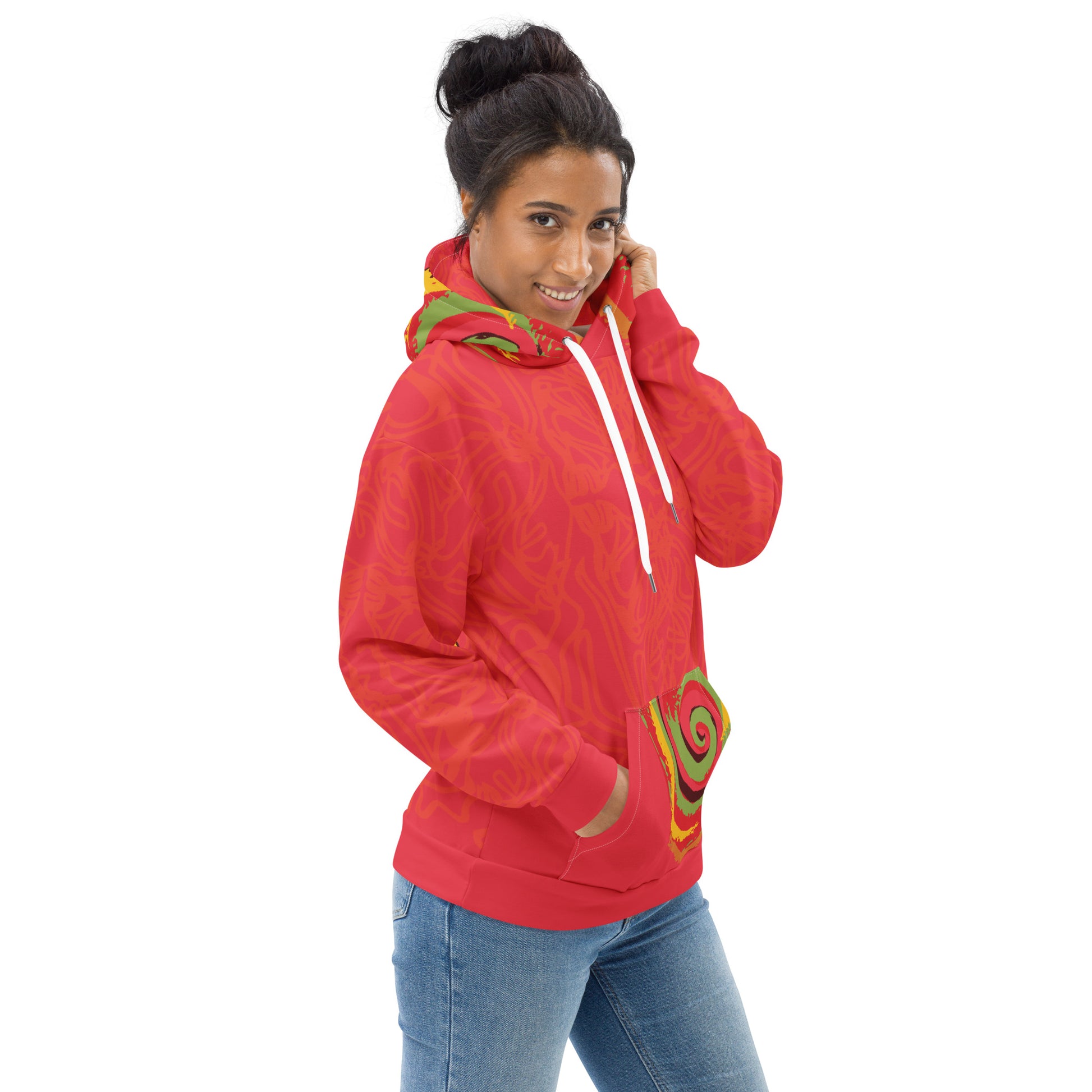 Red hoodie with bold spiral pocket design and mirrored face artwork on the back, inspired by cultural art and self-expression.