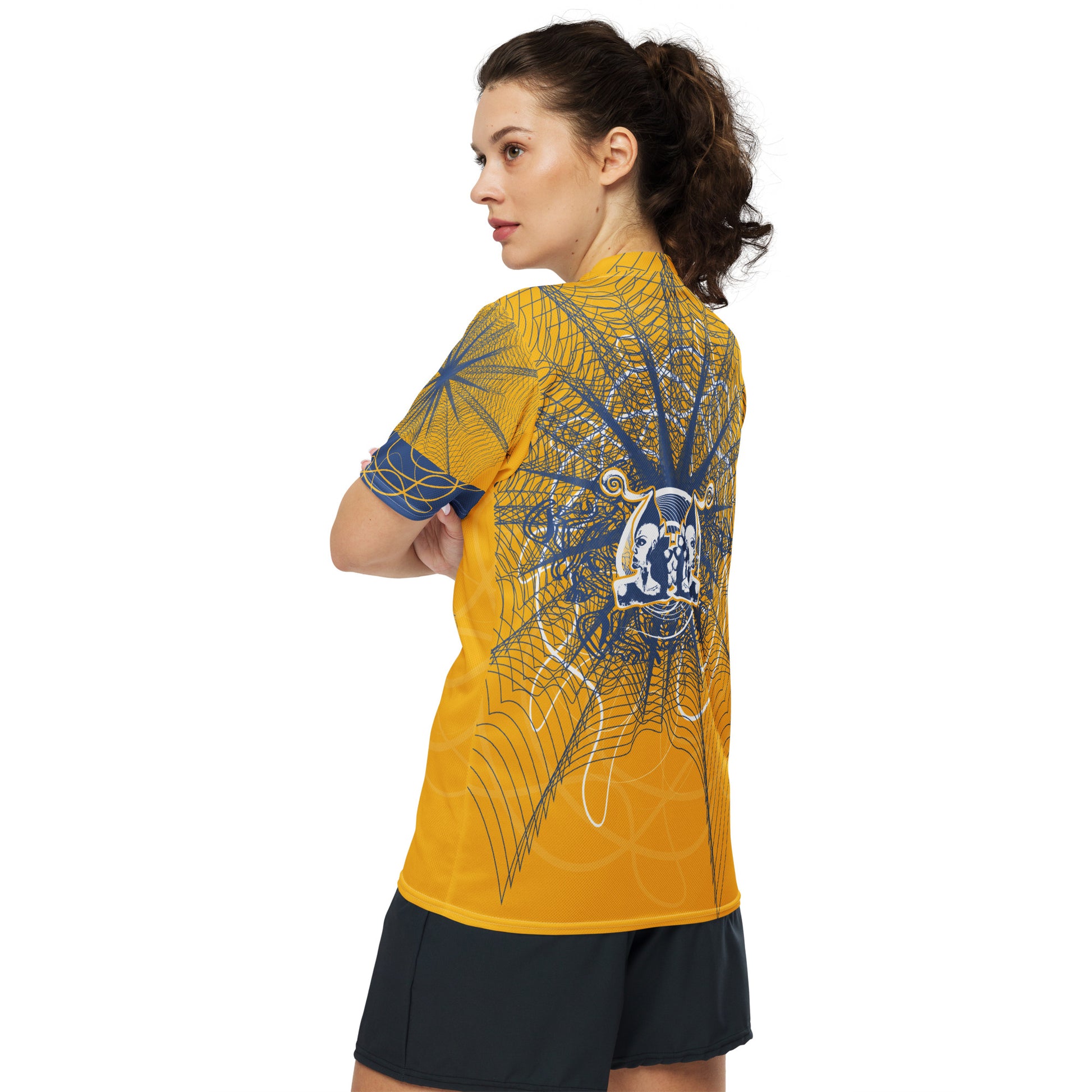 Back view of a golden yellow sports jersey showcasing layered navy geometric patterns and a mirrored face emblem, combining cultural symbolism with modern streetwear design.