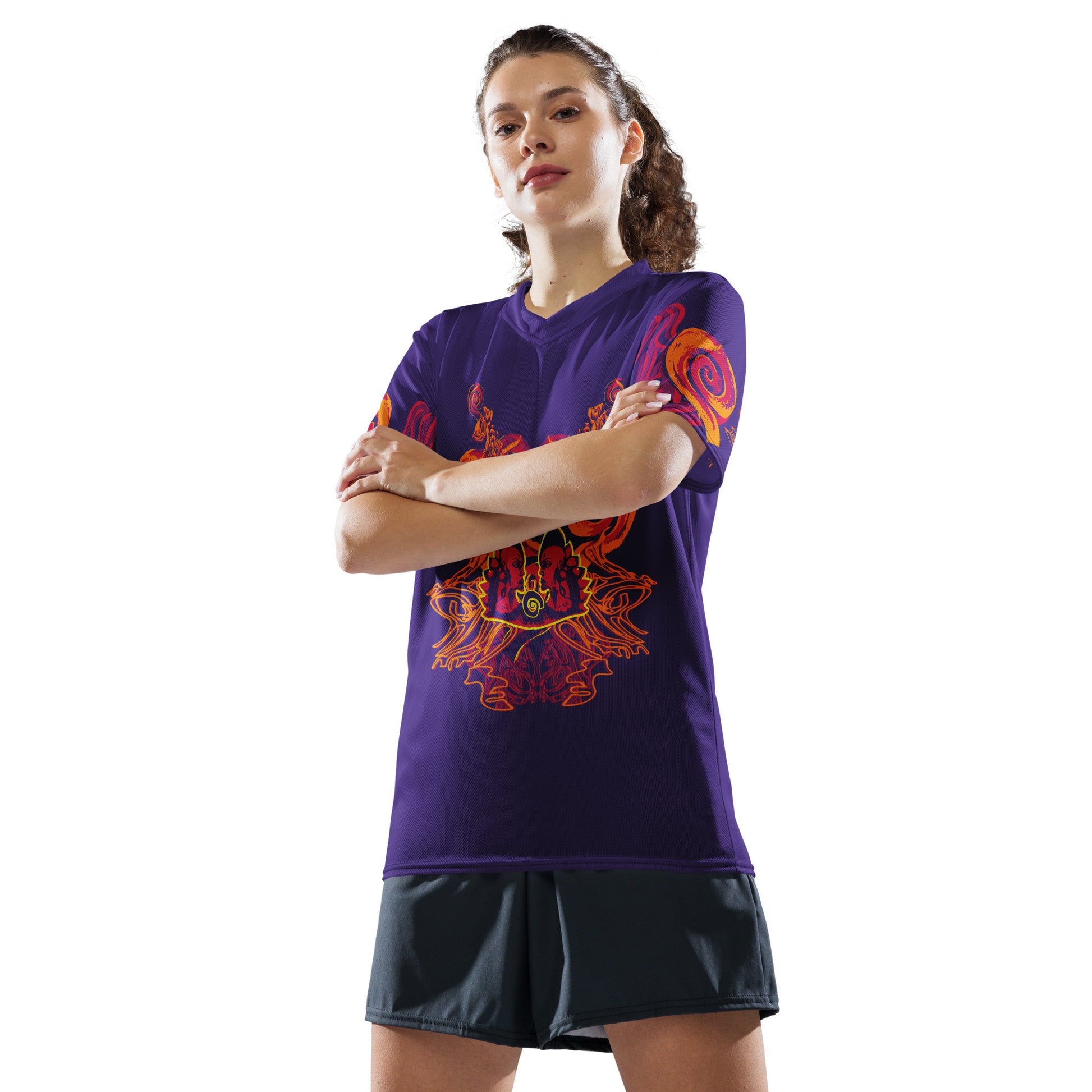 A model wearing a vibrant purple sports jersey with bold orange and red culturally inspired patterns, featuring mirrored faces and swirling designs – expressive fashion from KLOE’s The Secret Chambers of I & I collection.