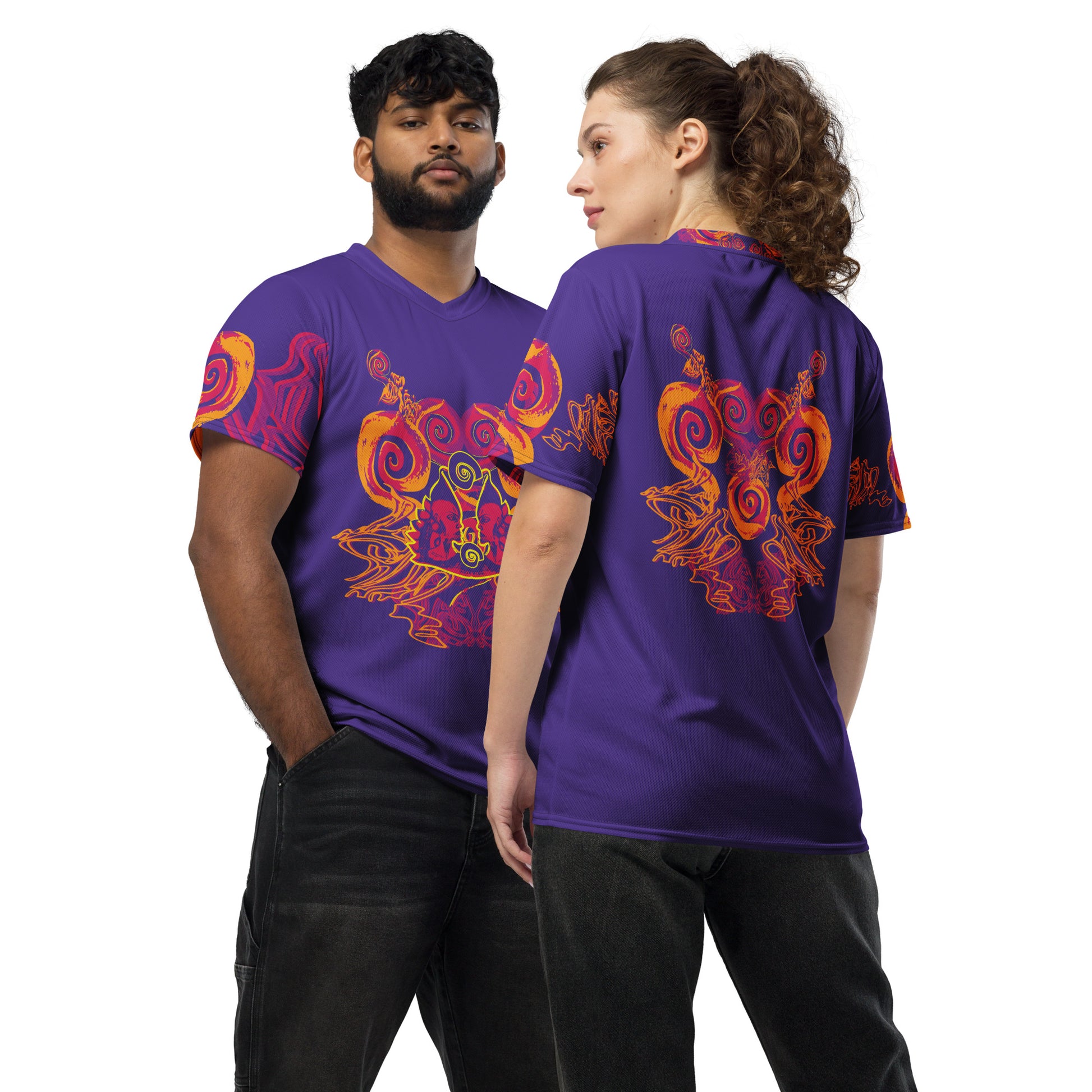 A model couple wearing a vibrant purple sports jersey with bold orange and red culturally inspired patterns, featuring mirrored faces and swirling designs – expressive fashion from KLOE’s The Secret Chambers of I & I collection.