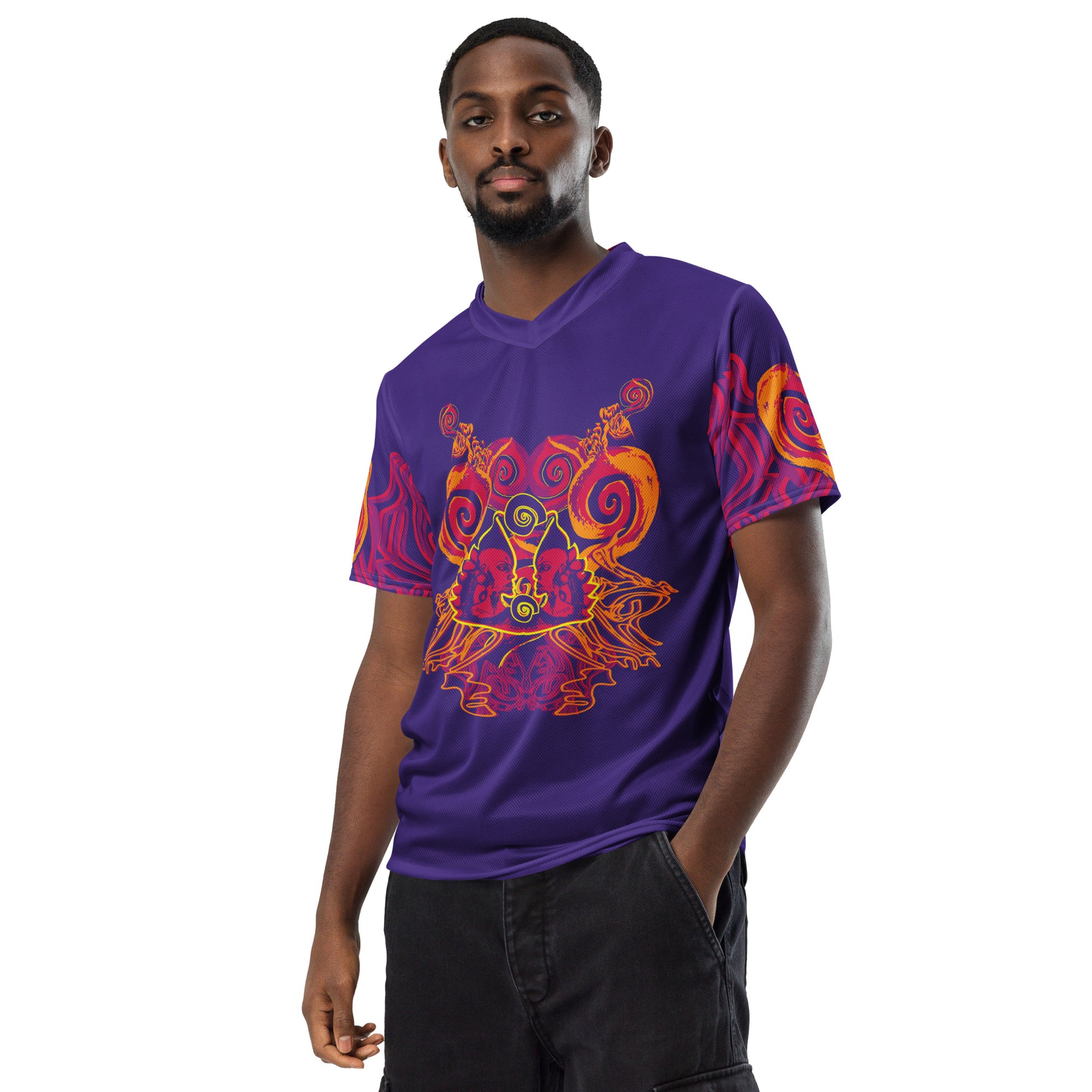 A model wearing a vibrant purple sports jersey with bold orange and red culturally inspired patterns, featuring mirrored faces and swirling designs – expressive fashion from KLOE’s The Secret Chambers of I & I collection.