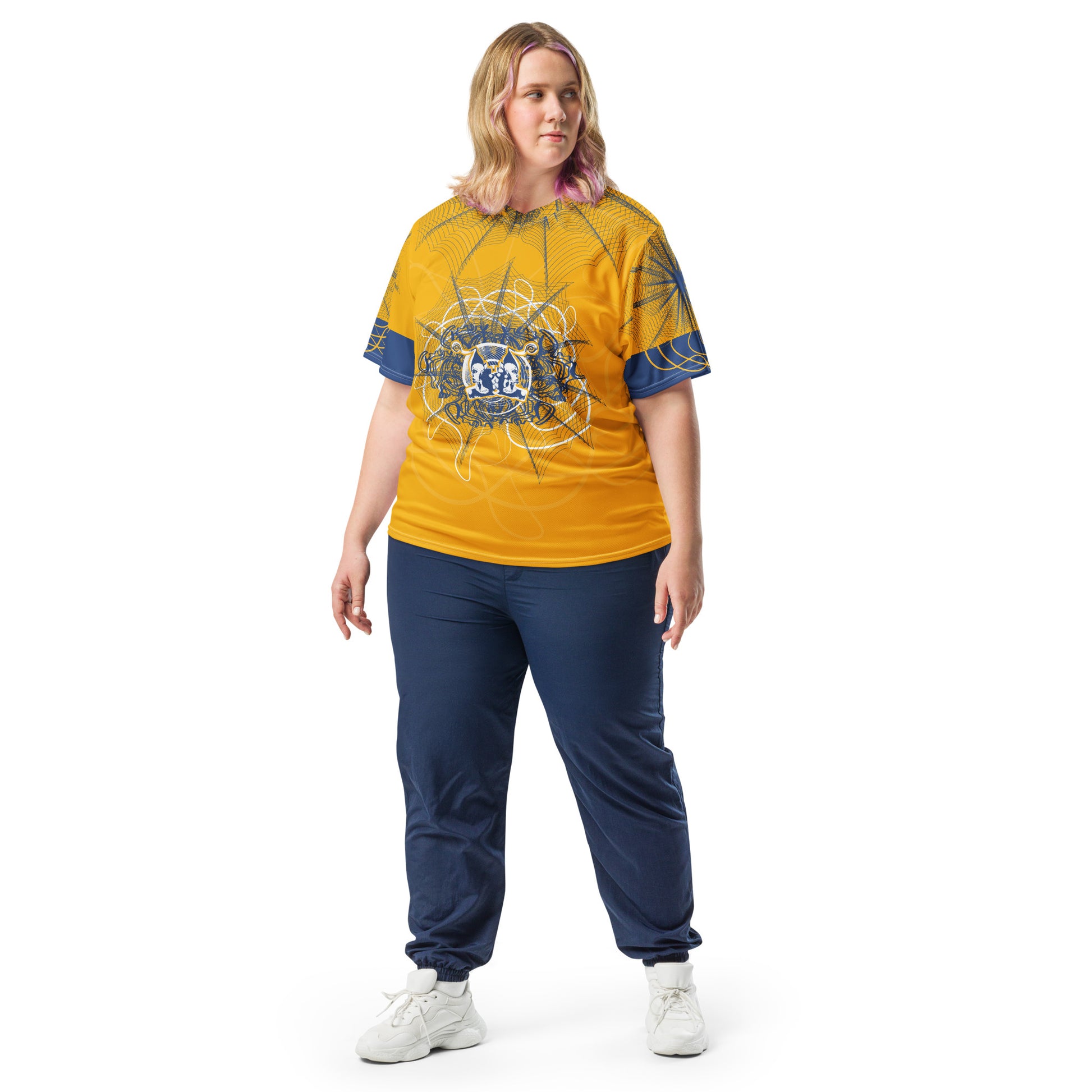 Front view of a golden yellow sports jersey featuring intricate navy web-like linework and a bold mirrored face design at the center, blending hand-drawn art with streetwear energy.