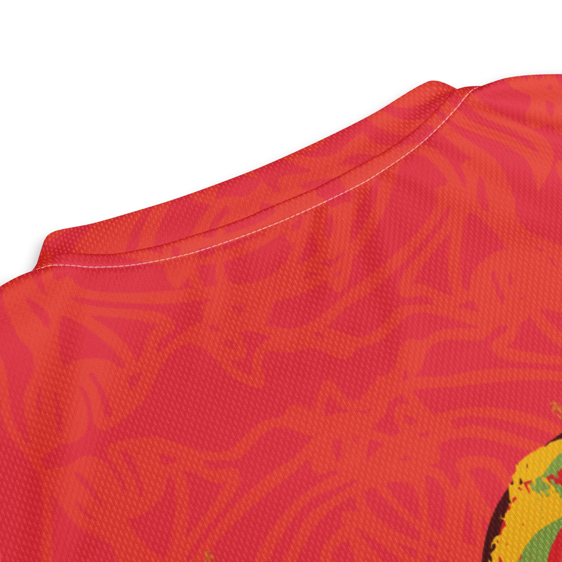 Red sports jersey with bold swirl on the front and mirrored face design on the back, inspired by cultural art and self-expression.