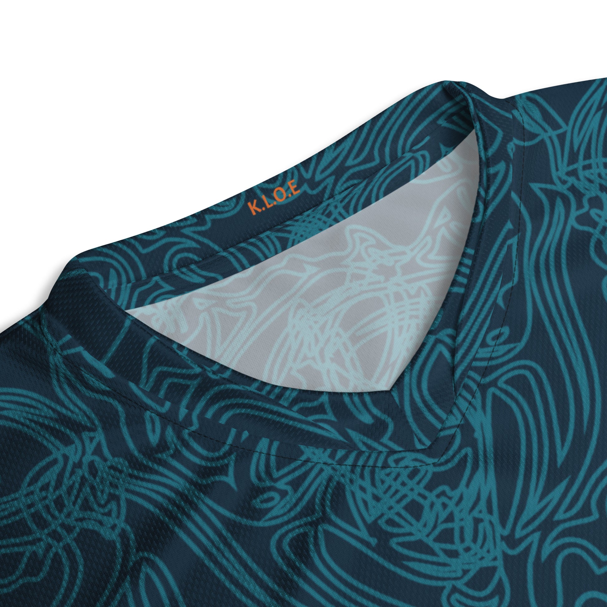 Neck view of a navy blue sports jersey featuring intricate cyan line art and bold orange tribal-inspired patterns.