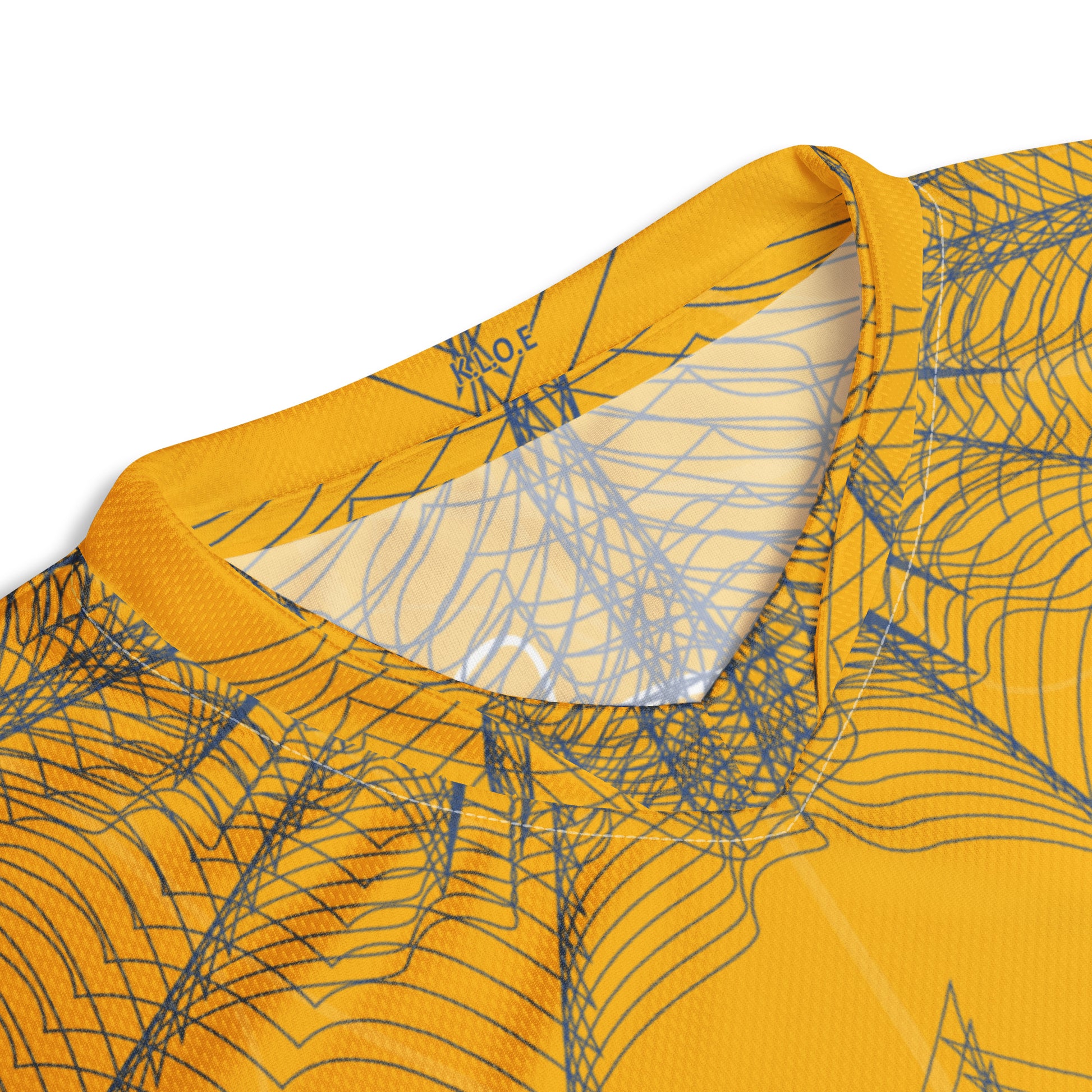 Front view of a golden yellow sports jersey featuring intricate navy web-like linework and a bold mirrored face design at the center, blending hand-drawn art with streetwear energy, showing details around the neckline.