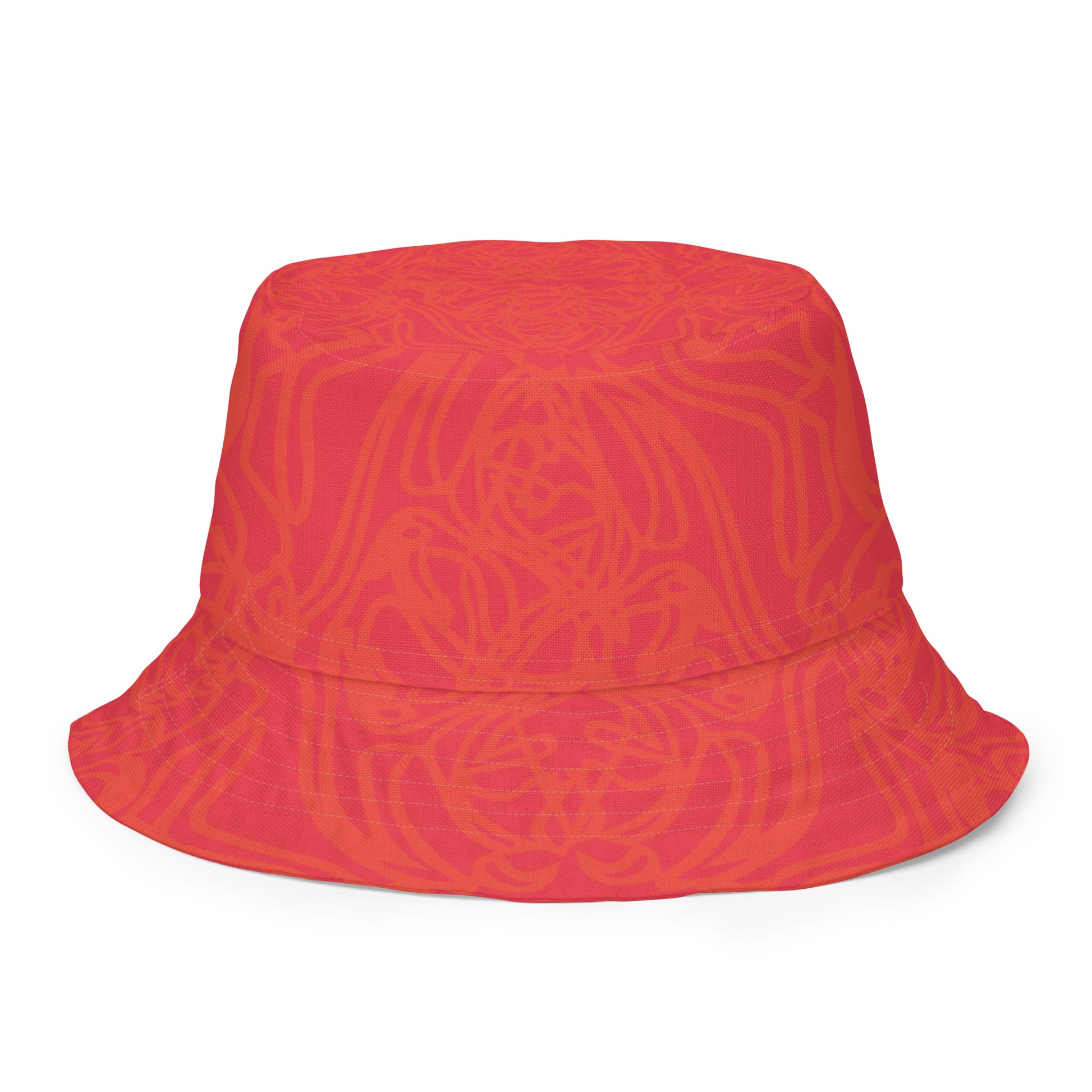 Reversible red-orange bucket hat with cultural swirl design and mirrored face motif on one side, and K.L.O.E wordmark on the other.