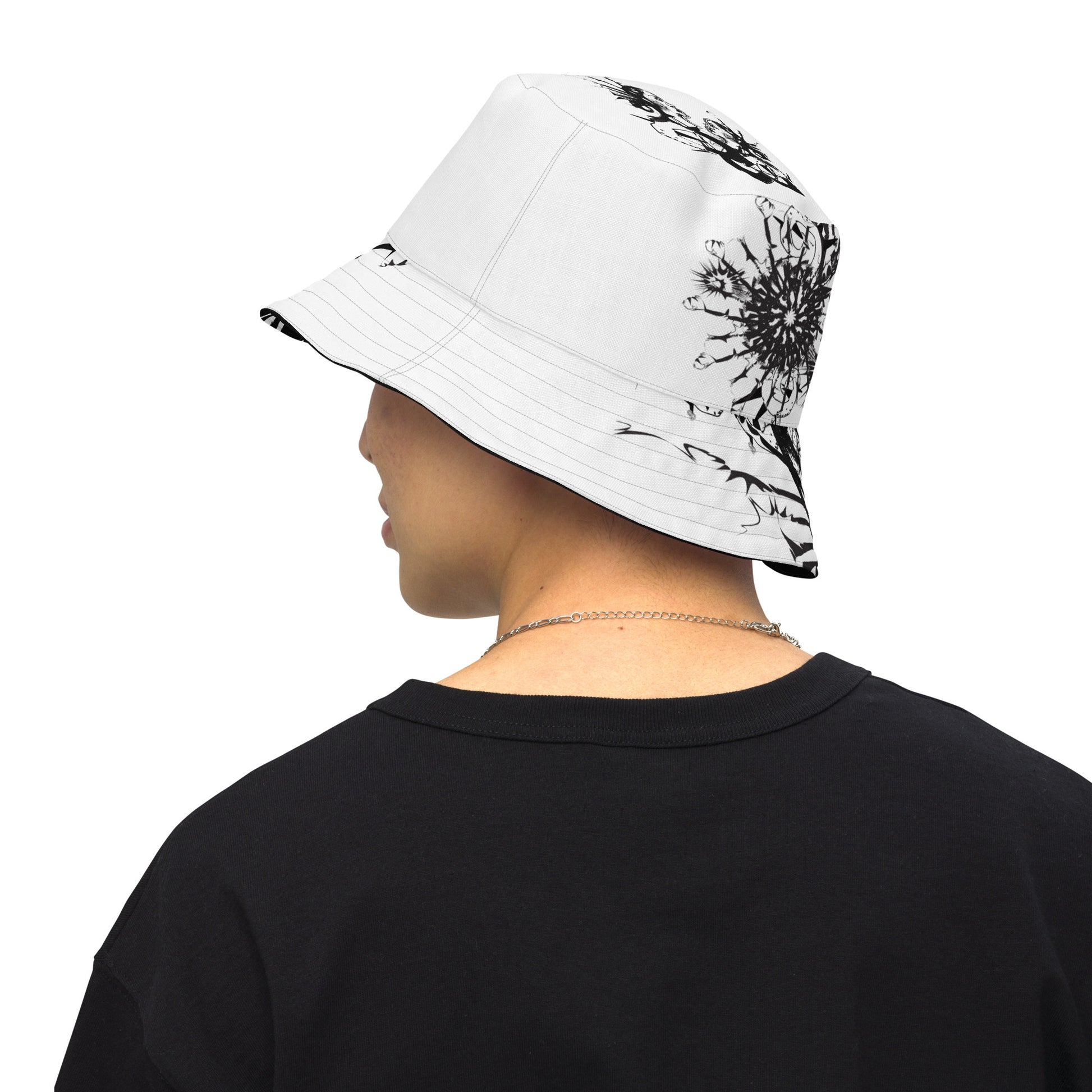 All-over print reversible bucket hat by K.L.O.E featuring black hand-drawn, culturally inspired artwork on a white background—expressing individuality and transformation through intricate abstract symbolism.
