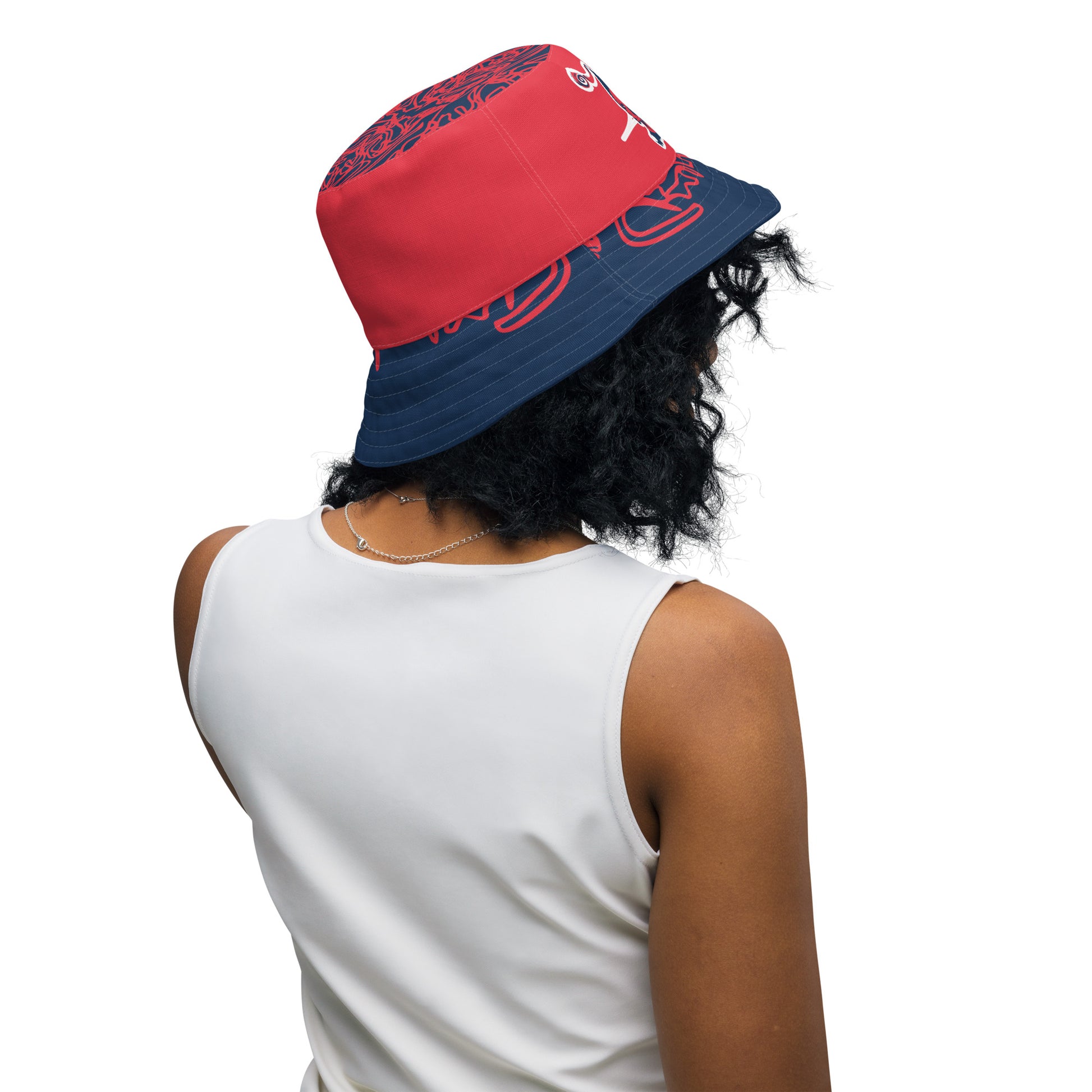 Bold reversible streetwear bucket hat featuring hand-drawn tribal patterns on one side and a mirrored face design on the other, crafted in navy and red for an edgy, modern look – KLOE fashion.