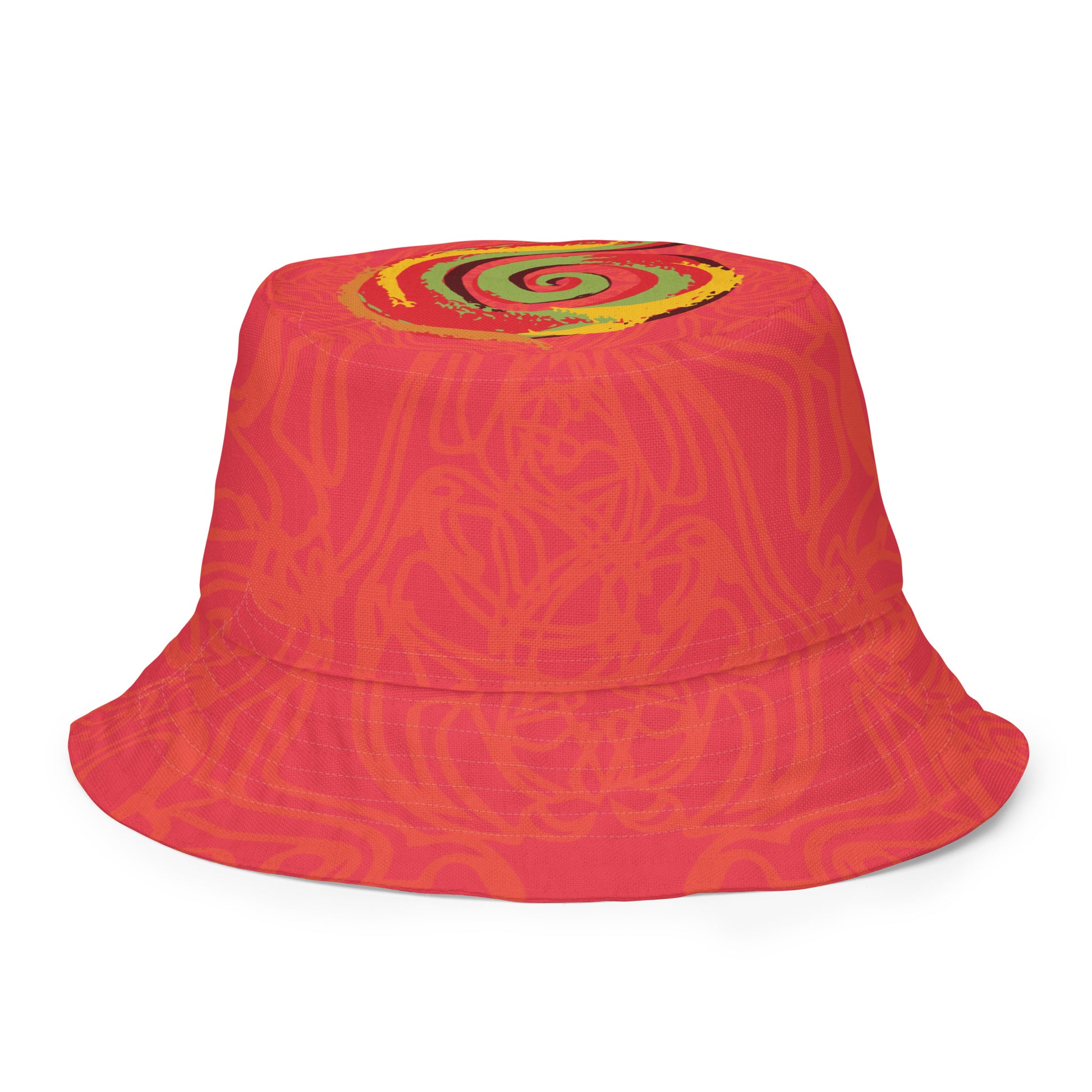 Reversible red-orange bucket hat with cultural swirl design and mirrored face motif on one side, and K.L.O.E wordmark on the other.
