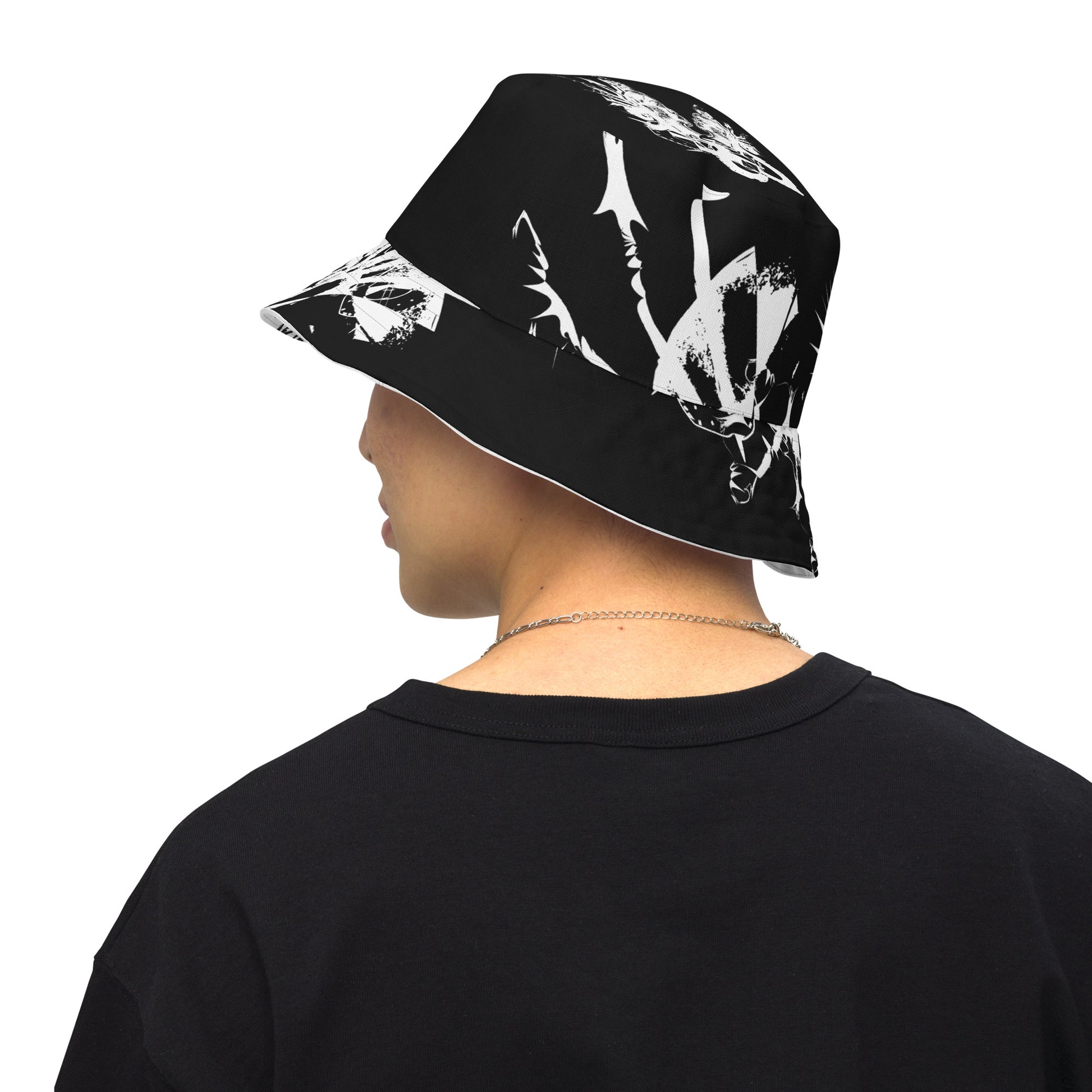 All-over print reversible bucket hat by K.L.O.E featuring white hand-drawn, culturally inspired artwork on a black background—symbolizing duality, individuality, and artistic transformation through abstract design.