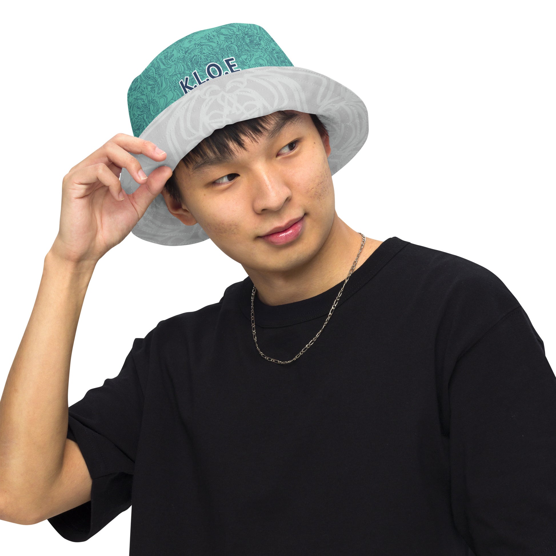 Reversible bucket hat with abstract jade and white linework, featuring dual-face artwork on one side and K.L.O.E logo on the other—crafted for bold, expressive style.