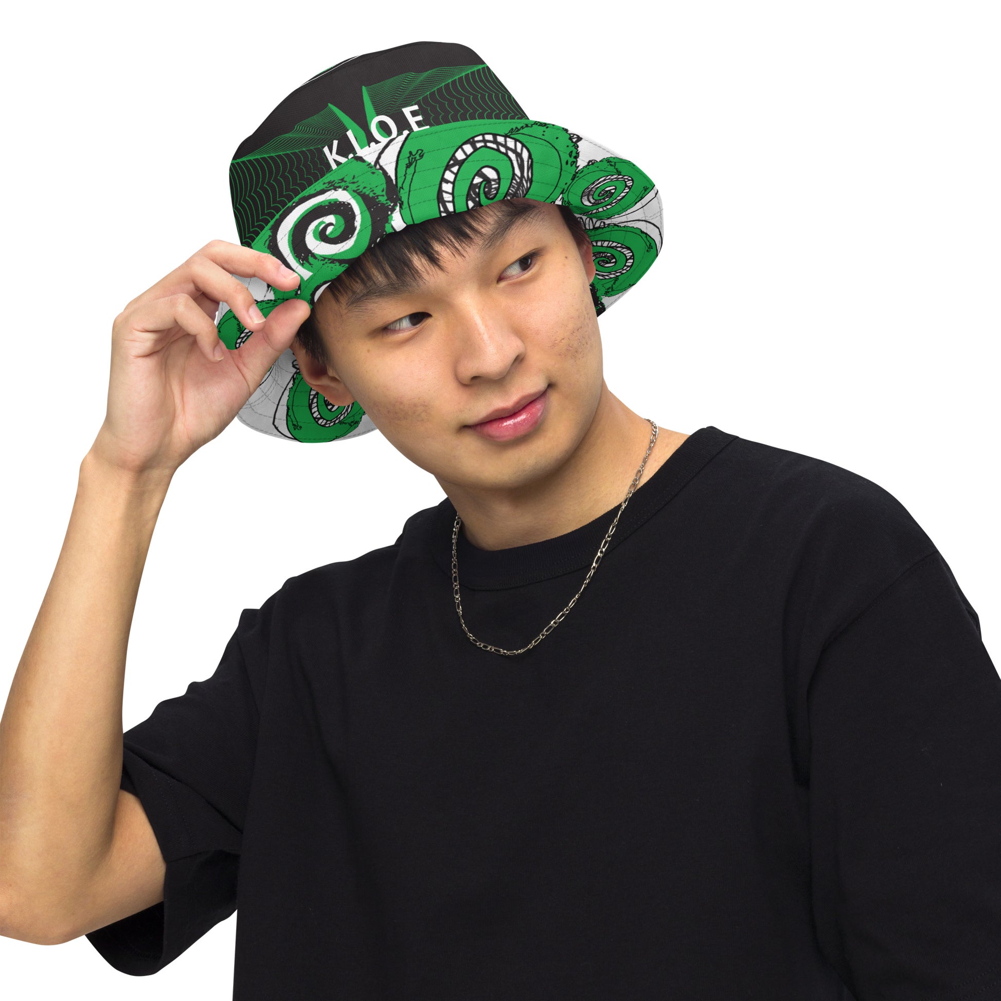Hand-illustrated reversible bucket hat featuring bold green spirals and intricate web-inspired patterns — crafted for versatile self-expression and rooted in artistic individuality, exclusive to KLOE.
