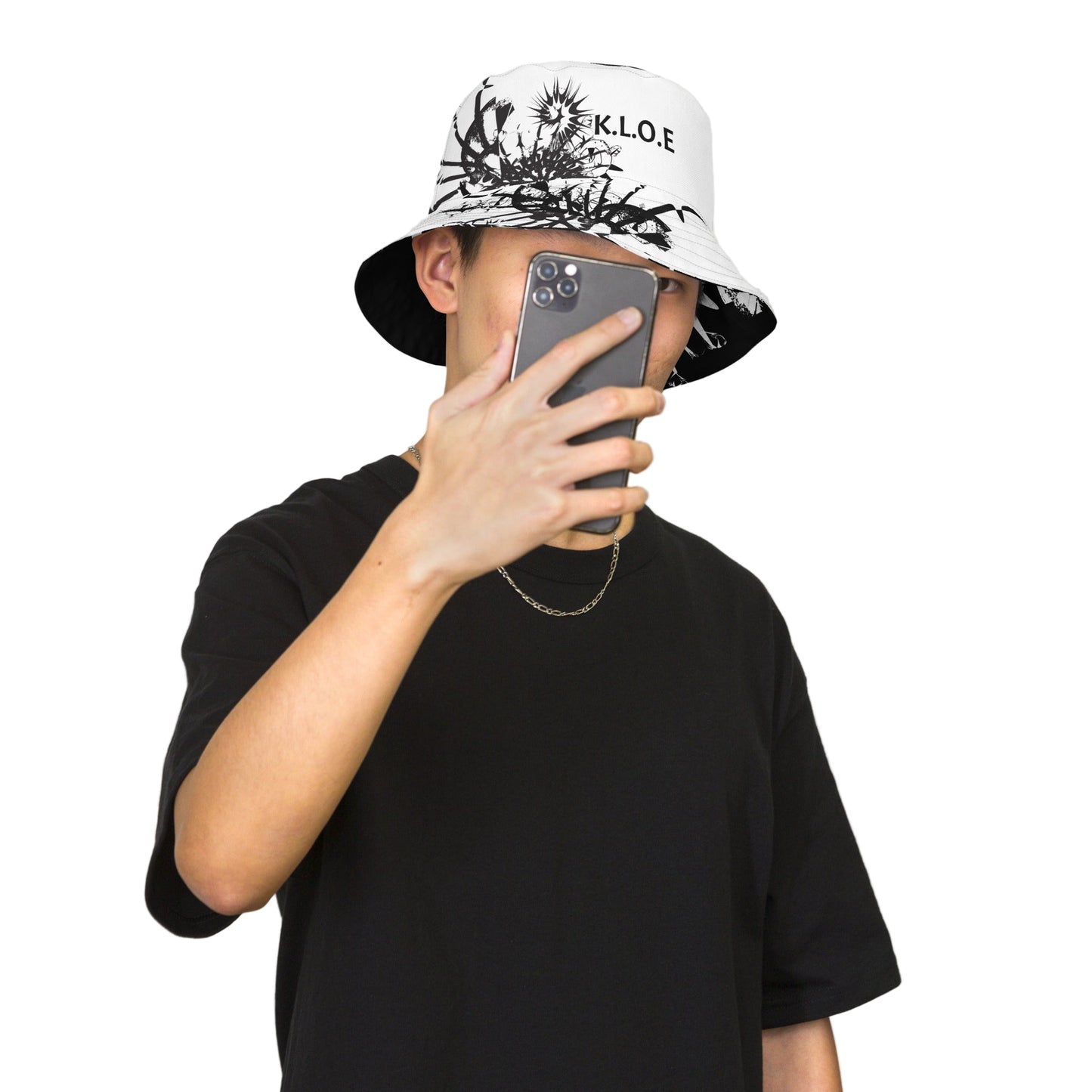 All-over print reversible bucket hat by K.L.O.E featuring black hand-drawn, culturally inspired artwork on a white background—expressing individuality and transformation through intricate abstract symbolism.
