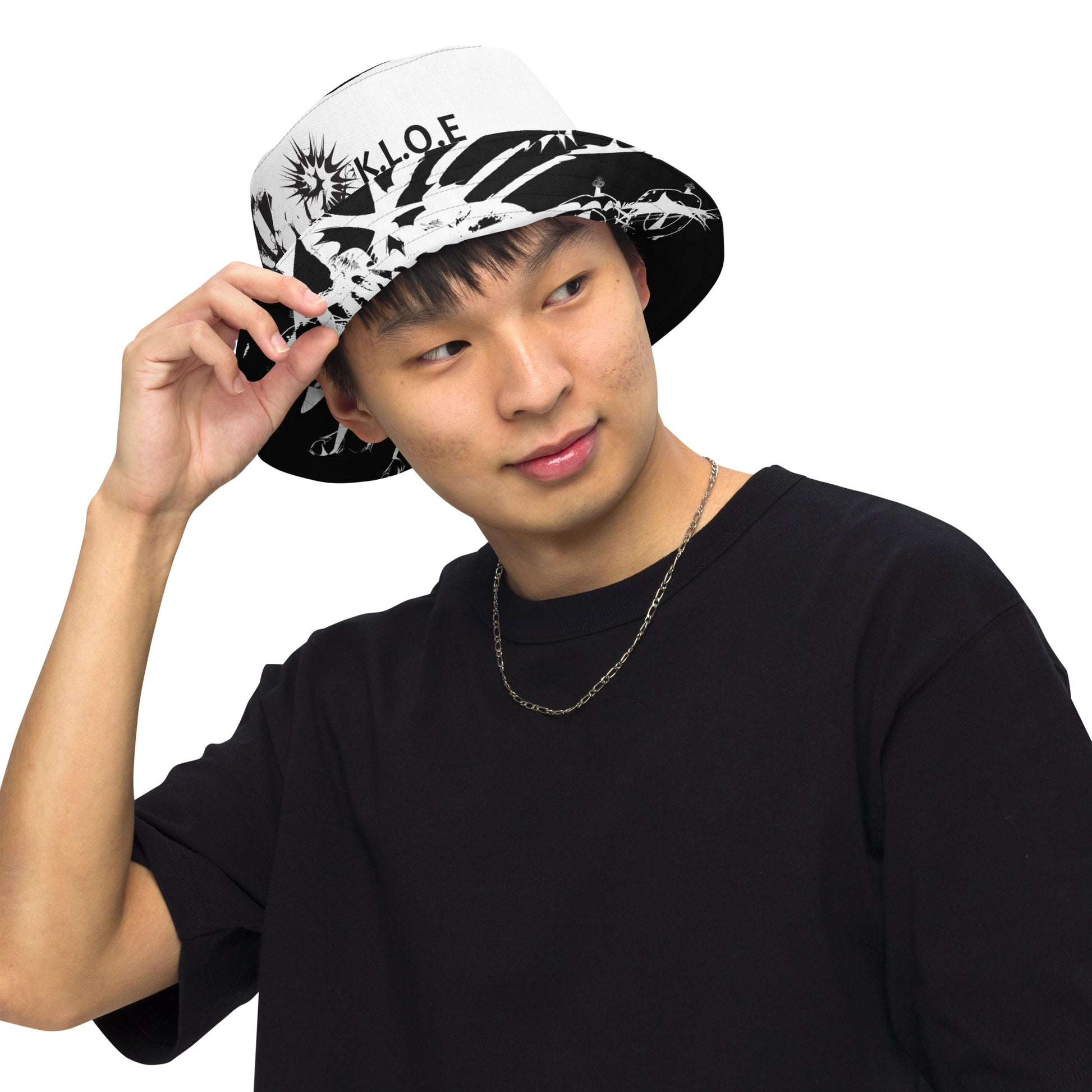 All-over print reversible bucket hat by K.L.O.E featuring black hand-drawn, culturally inspired artwork on a white background—expressing individuality and transformation through intricate abstract symbolism.