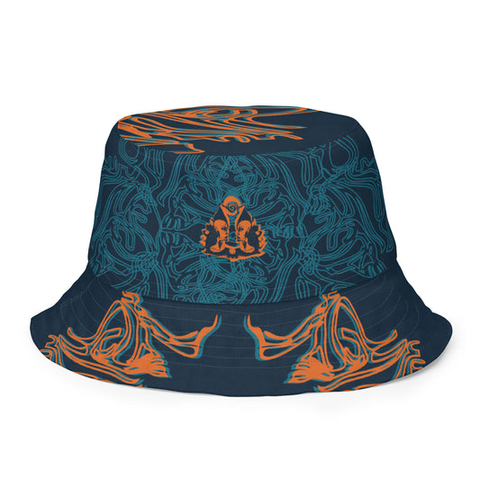 Reversible bucket hat featuring a small orange mirrored face motif and bold tribal-inspired patterns, blending art and streetwear.