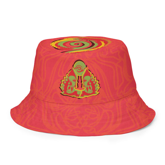 Reversible red-orange bucket hat with cultural swirl design and mirrored face motif on one side, and K.L.O.E wordmark on the other.
