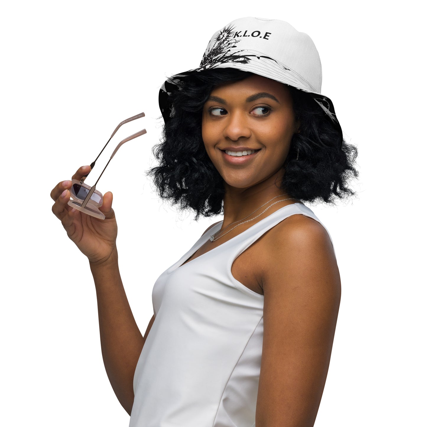 All-over print reversible bucket hat by K.L.O.E featuring black hand-drawn, culturally inspired artwork on a white background—expressing individuality and transformation through intricate abstract symbolism.