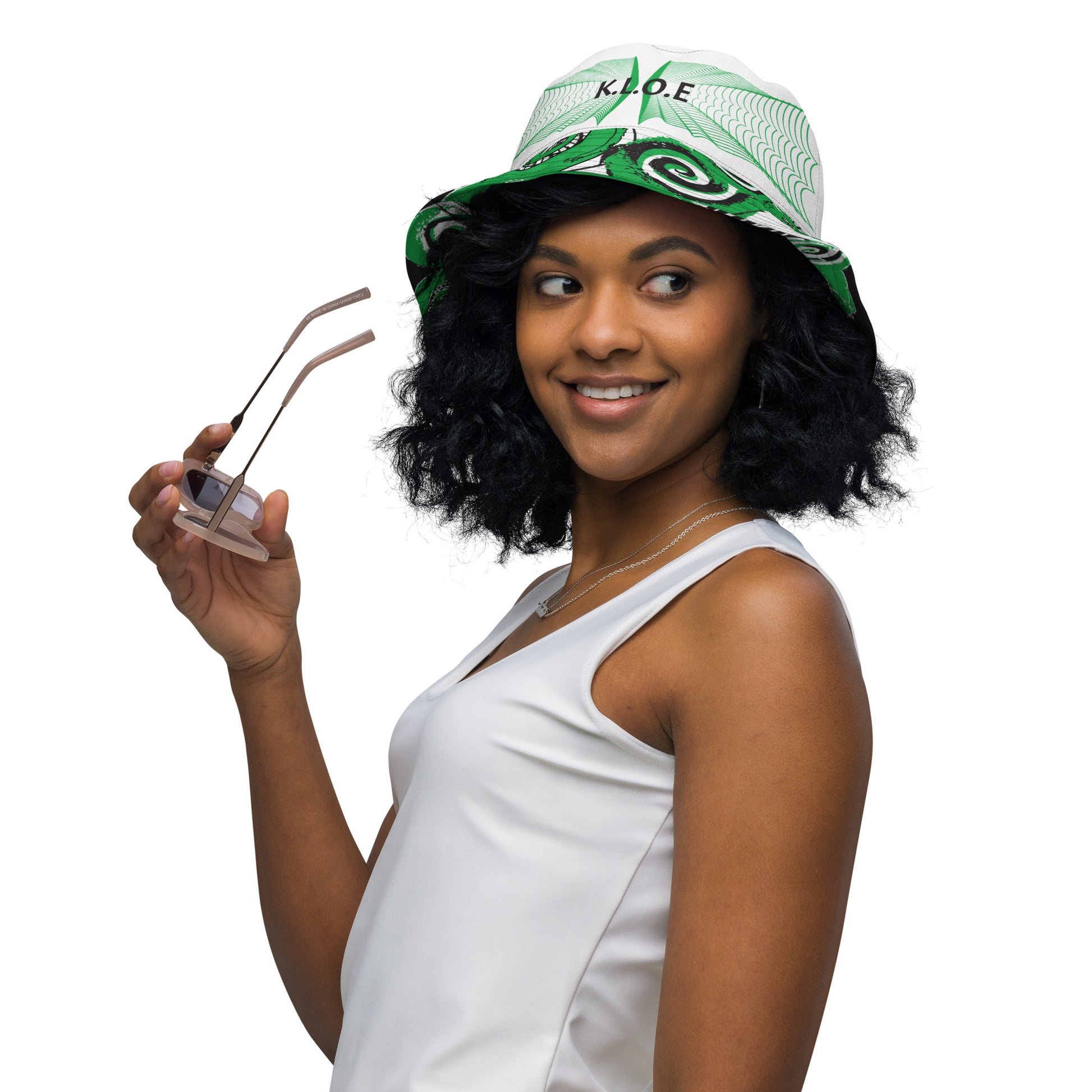 Hand-illustrated reversible bucket hat featuring bold green spirals and intricate web-inspired patterns — crafted for versatile self-expression and rooted in artistic individuality, exclusive to KLOE.