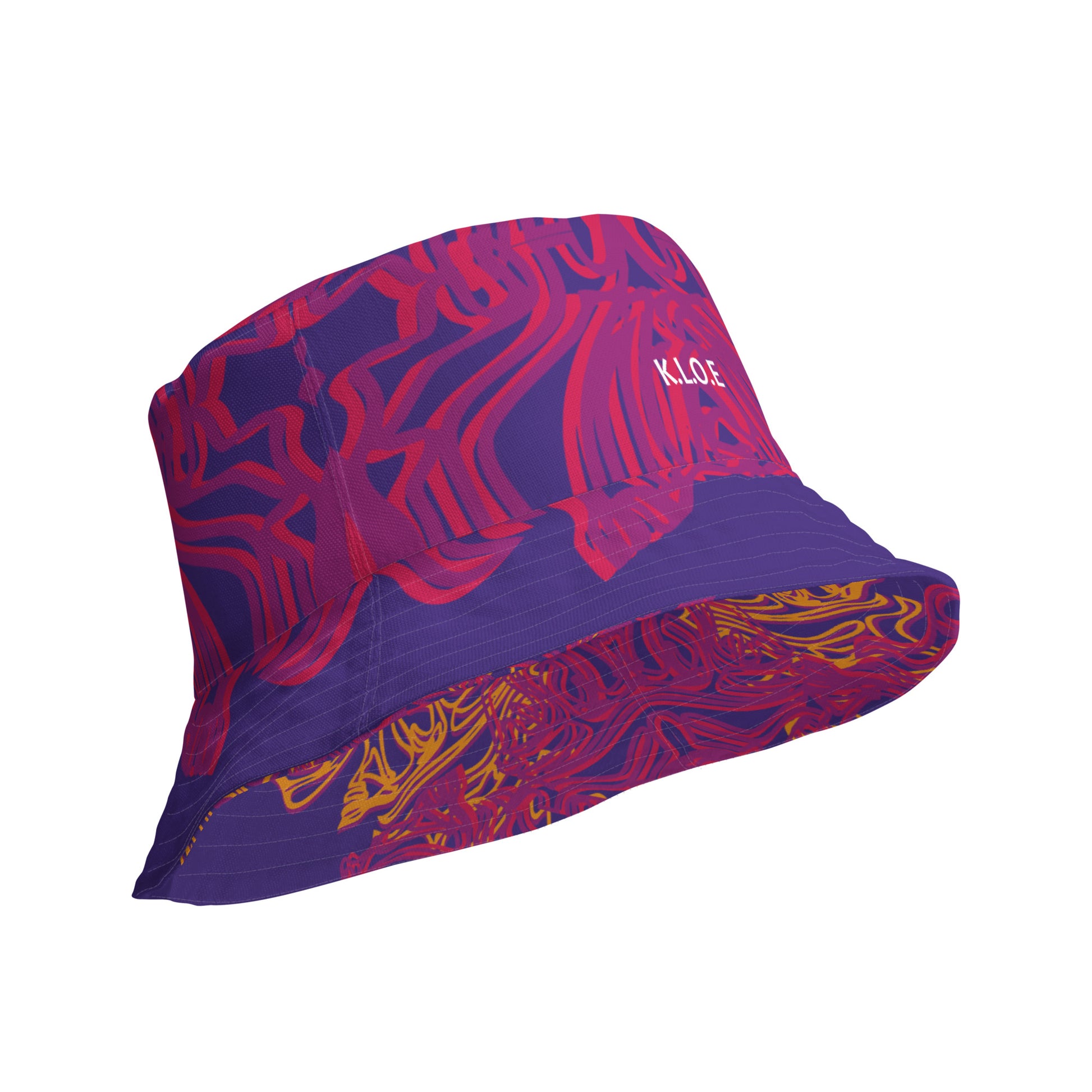Reversible purple bucket hat with bold orange and red culturally inspired patterns, featuring abstract swirls and mirrored face design — artistic fashion accessory from KLOE’s The Secret Chambers of I & I collection.