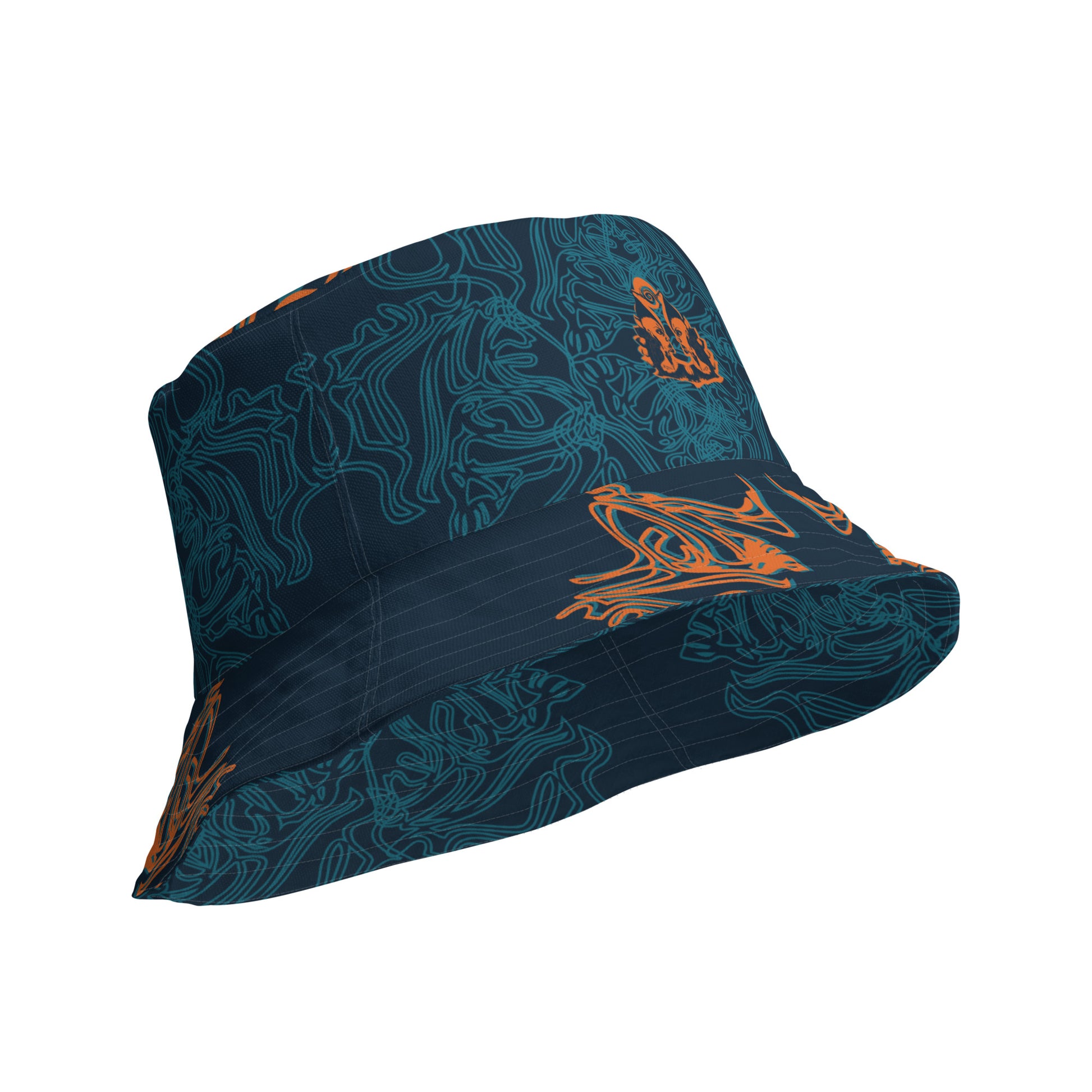 Reversible bucket hat featuring a small orange mirrored face motif and bold tribal-inspired patterns, blending art and streetwear.