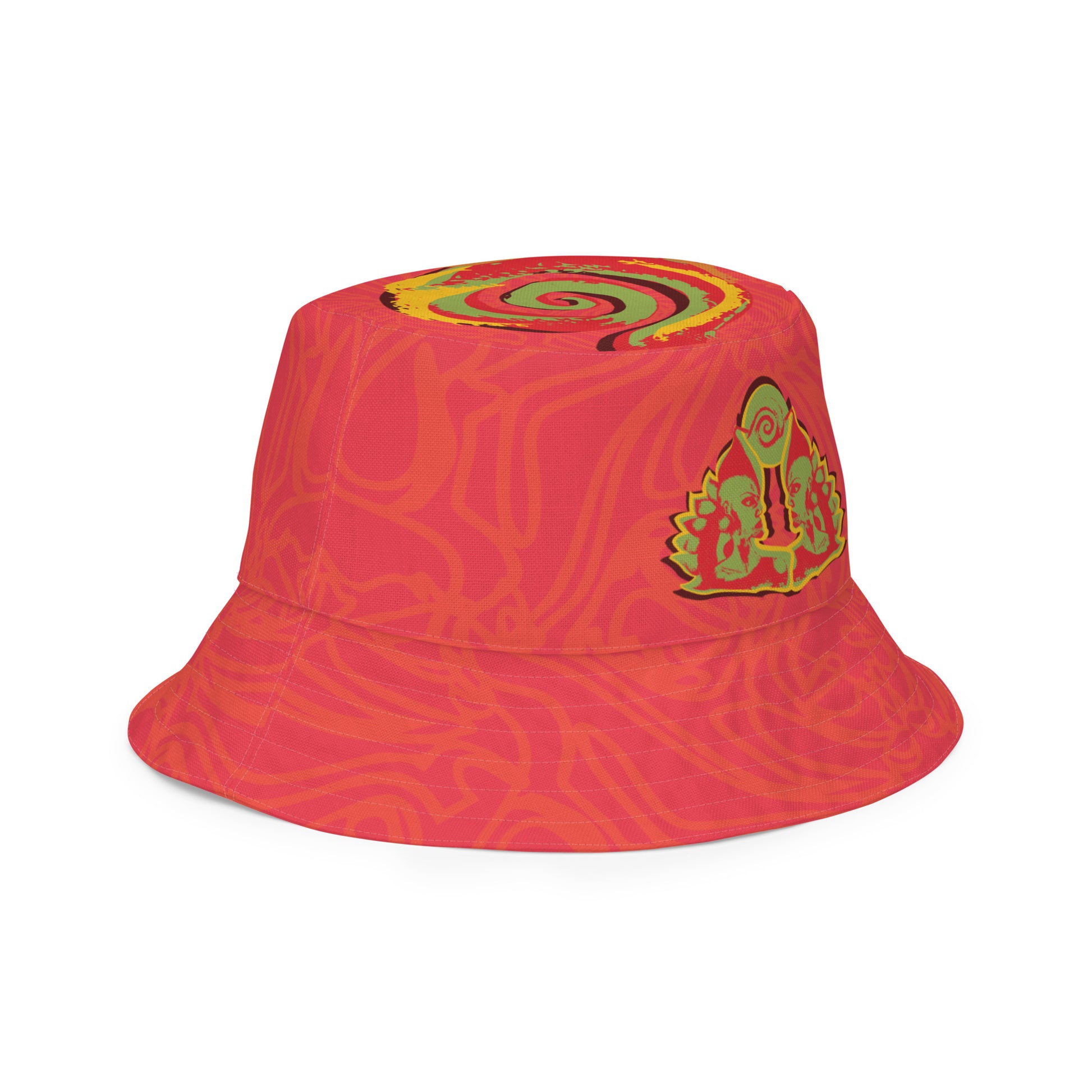 Reversible red-orange bucket hat with cultural swirl design and mirrored face motif on one side, and K.L.O.E wordmark on the other.