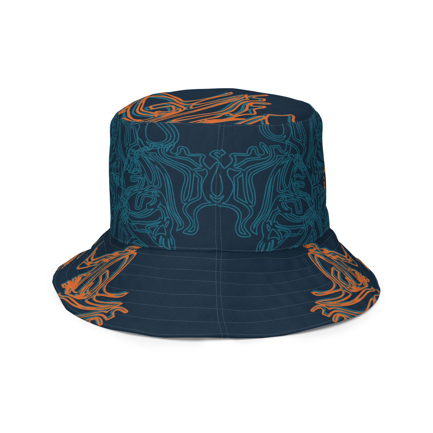 Reversible bucket hat featuring a small orange mirrored face motif and bold tribal-inspired patterns, blending art and streetwear.