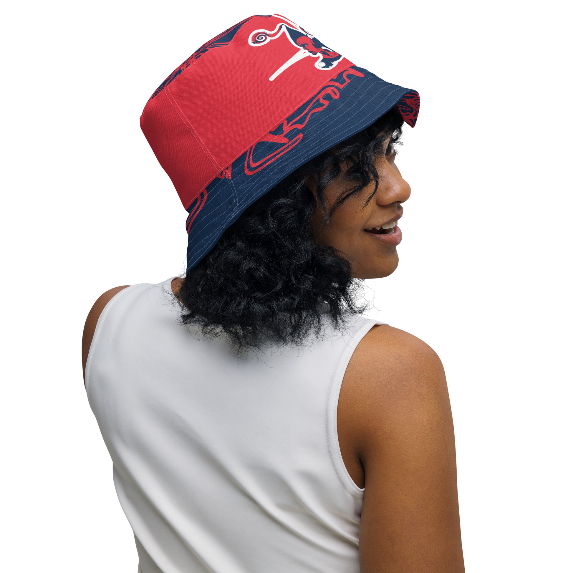 Bold reversible streetwear bucket hat featuring hand-drawn tribal patterns on one side and a mirrored face design on the other, crafted in navy and red for an edgy, modern look – KLOE fashion.