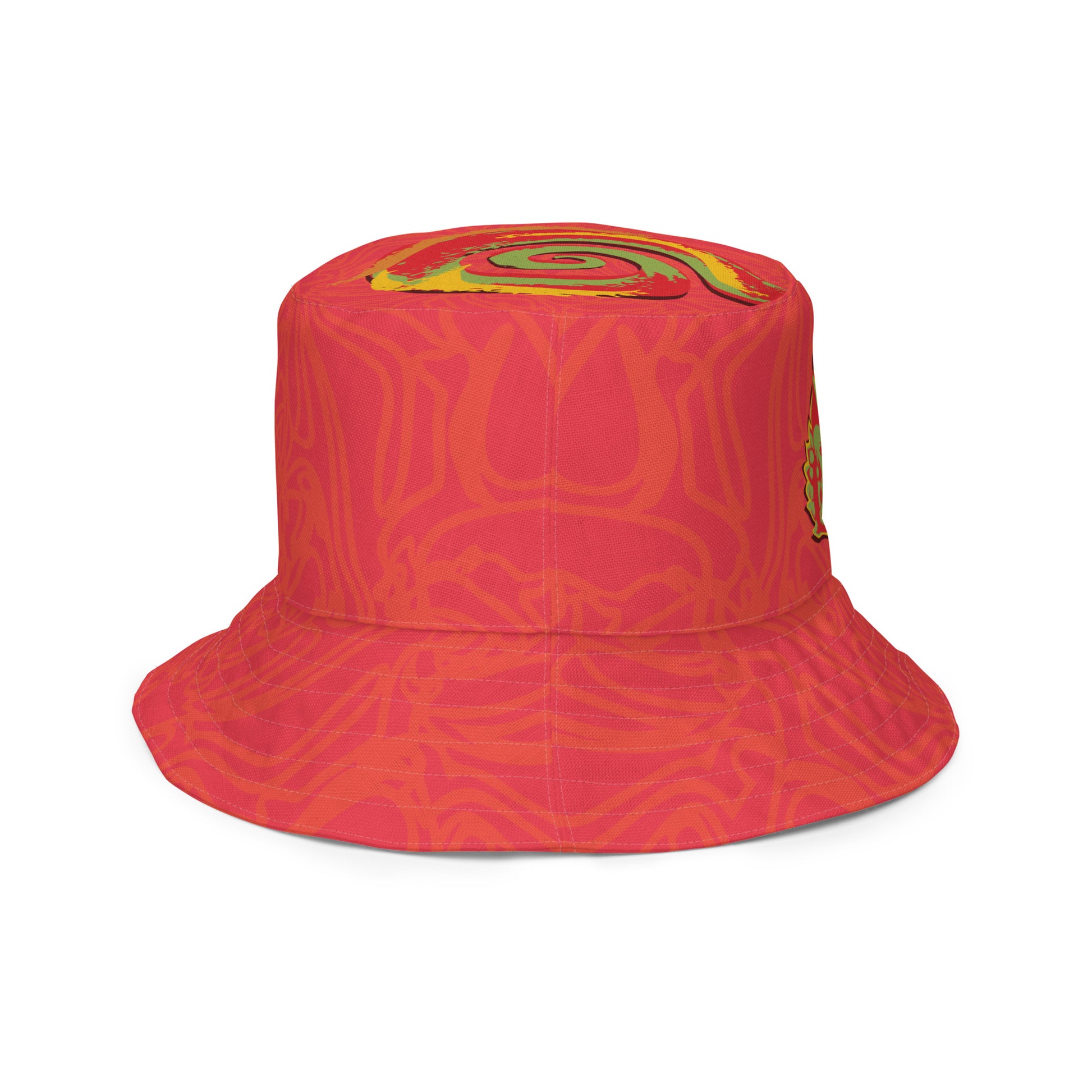 Reversible red-orange bucket hat with cultural swirl design and mirrored face motif on one side, and K.L.O.E wordmark on the other.