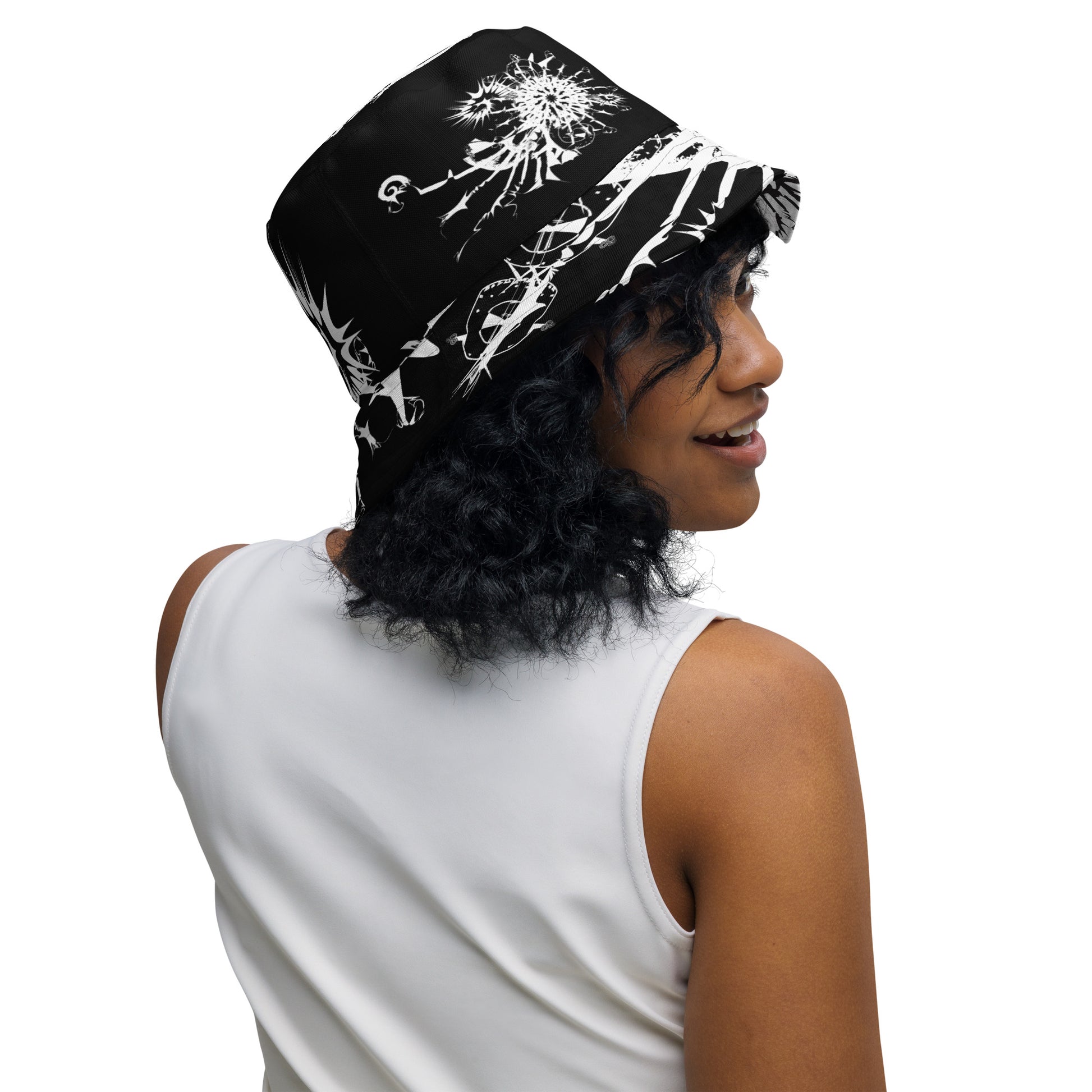 All-over print reversible bucket hat by K.L.O.E featuring white hand-drawn, culturally inspired artwork on a black background—symbolizing duality, individuality, and artistic transformation through abstract design.