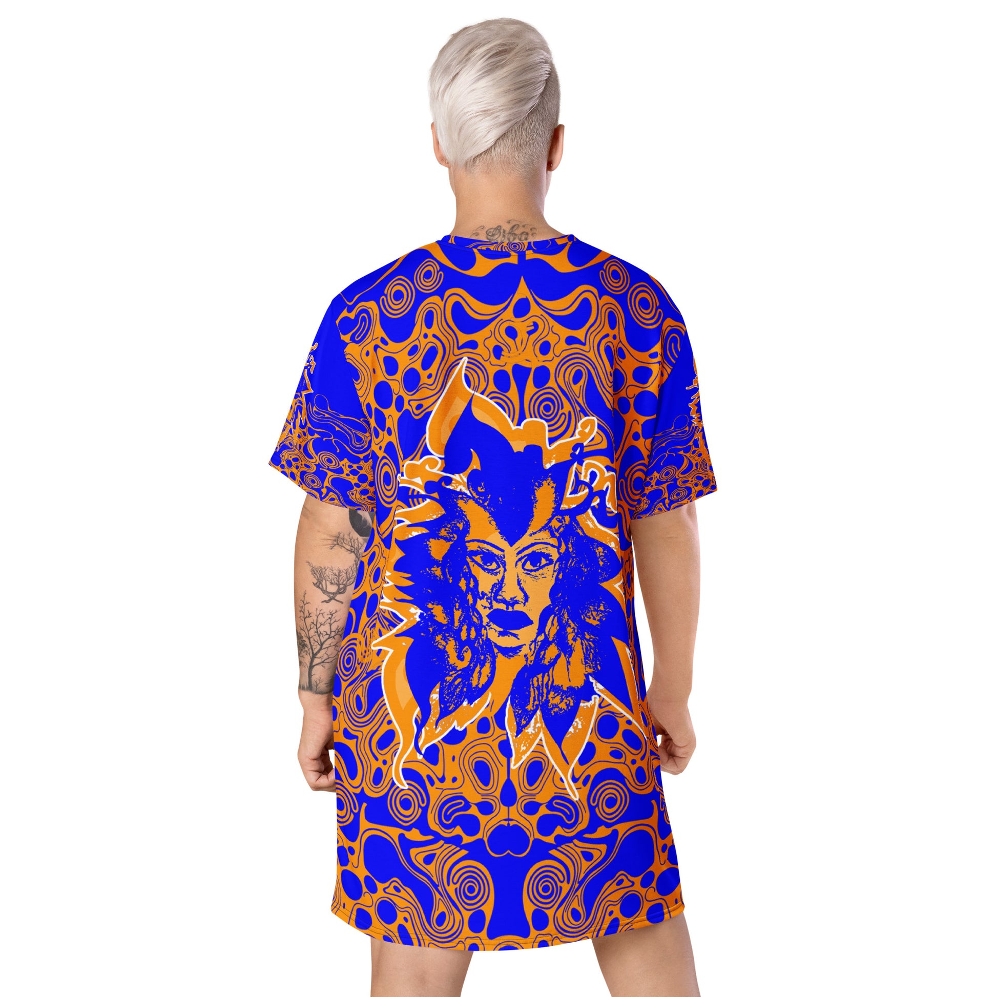 A model wearing bold blue and orange t-shirt dress from Kloe Store featuring intricate abstract patterns and a central artistic face design, offering a stylish and edgy streetwear look.