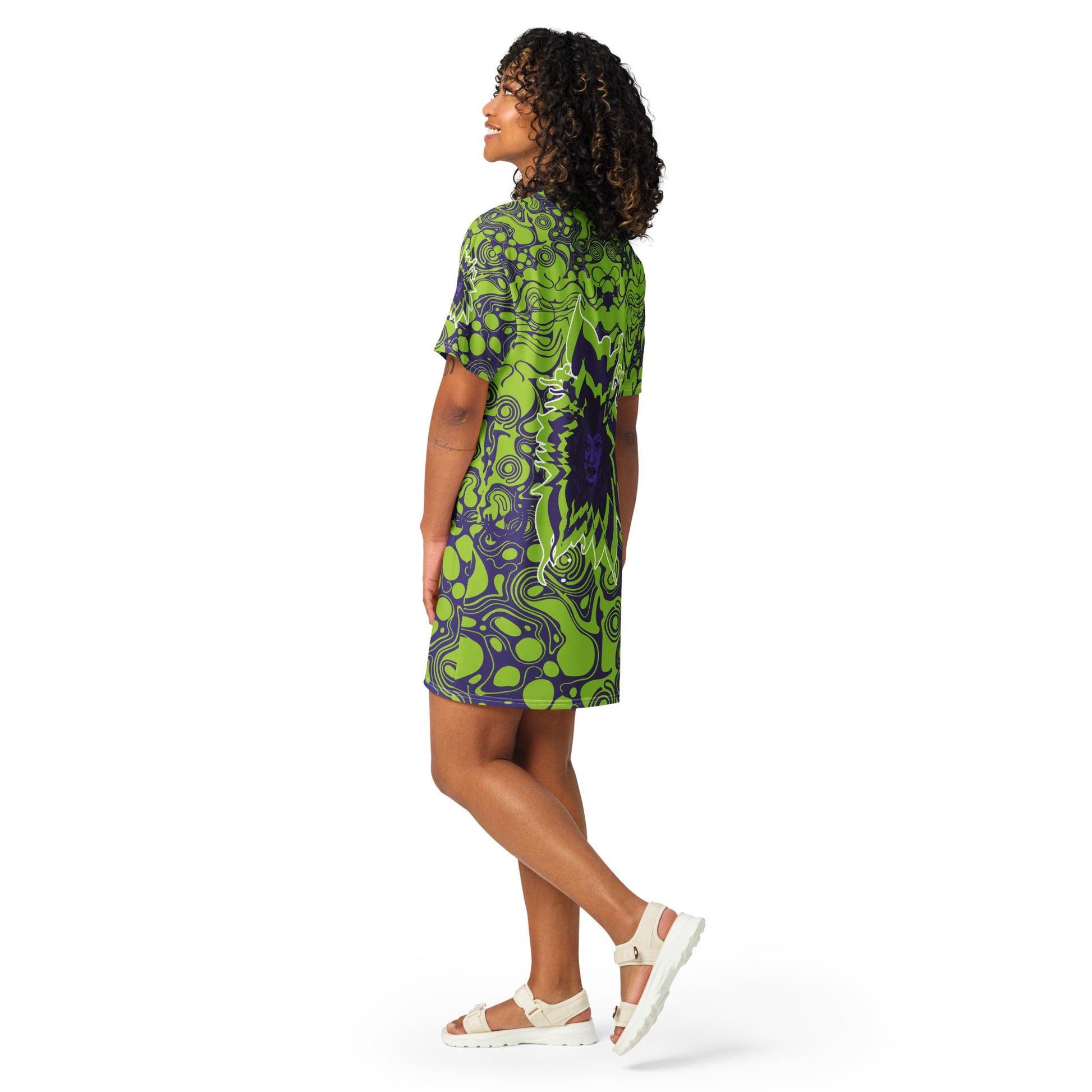A model wearing green and purple t-shirt dress from Kloe Store featuring bold abstract patterns and a unique central artistic face design, perfect for a trendy and edgy streetwear style.