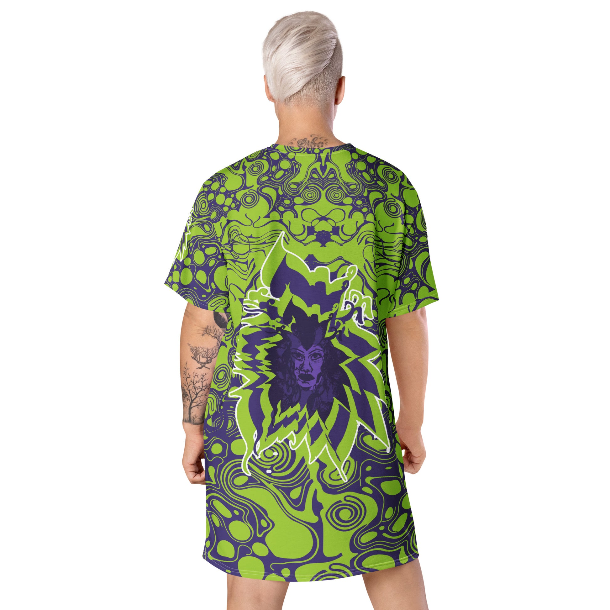 A model wearing green and purple t-shirt dress from Kloe Store featuring bold abstract patterns and a unique central artistic face design, perfect for a trendy and edgy streetwear style.