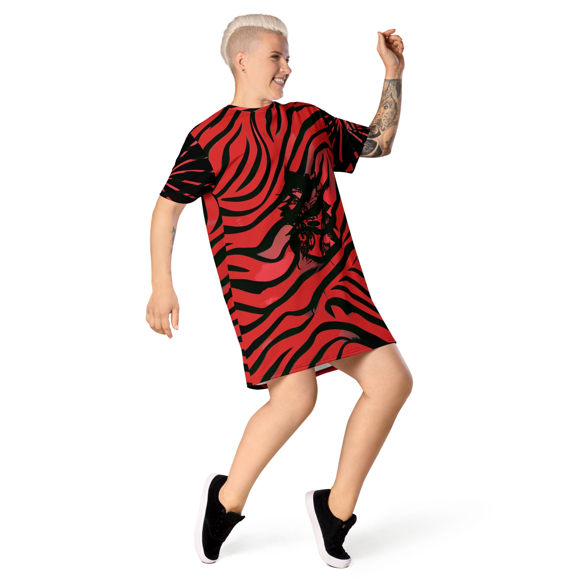Model wearing a bold red and black t-shirt dress from Kloe Store with an artistic face design, showcasing a stylish and edgy streetwear look with striking patterns and a modern, casual fit.