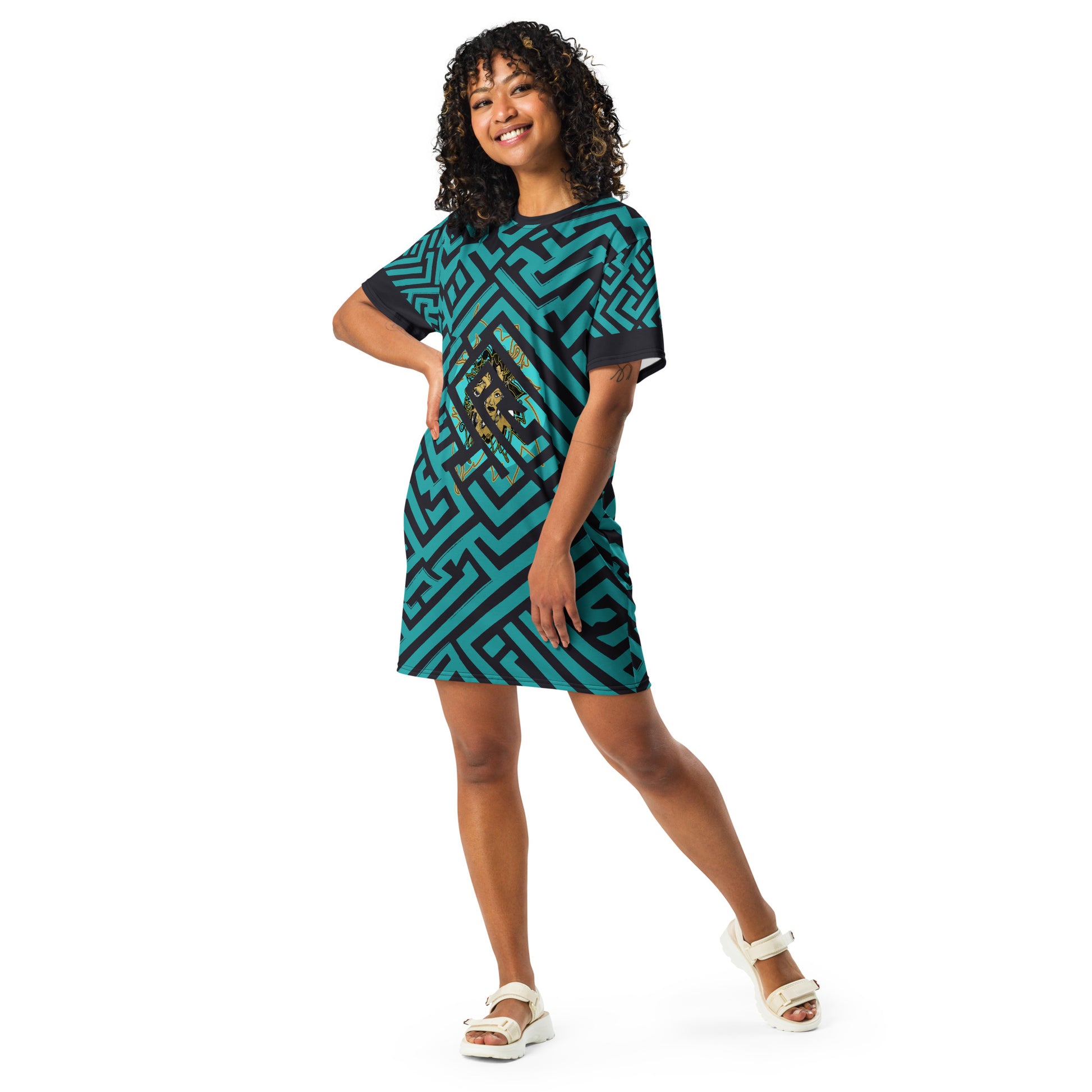 A model wearing KLOE bohemian style dress featuring bold green and black geometric patterns with a central golden artistic face design, showcasing expressive and modern boho style fashion.