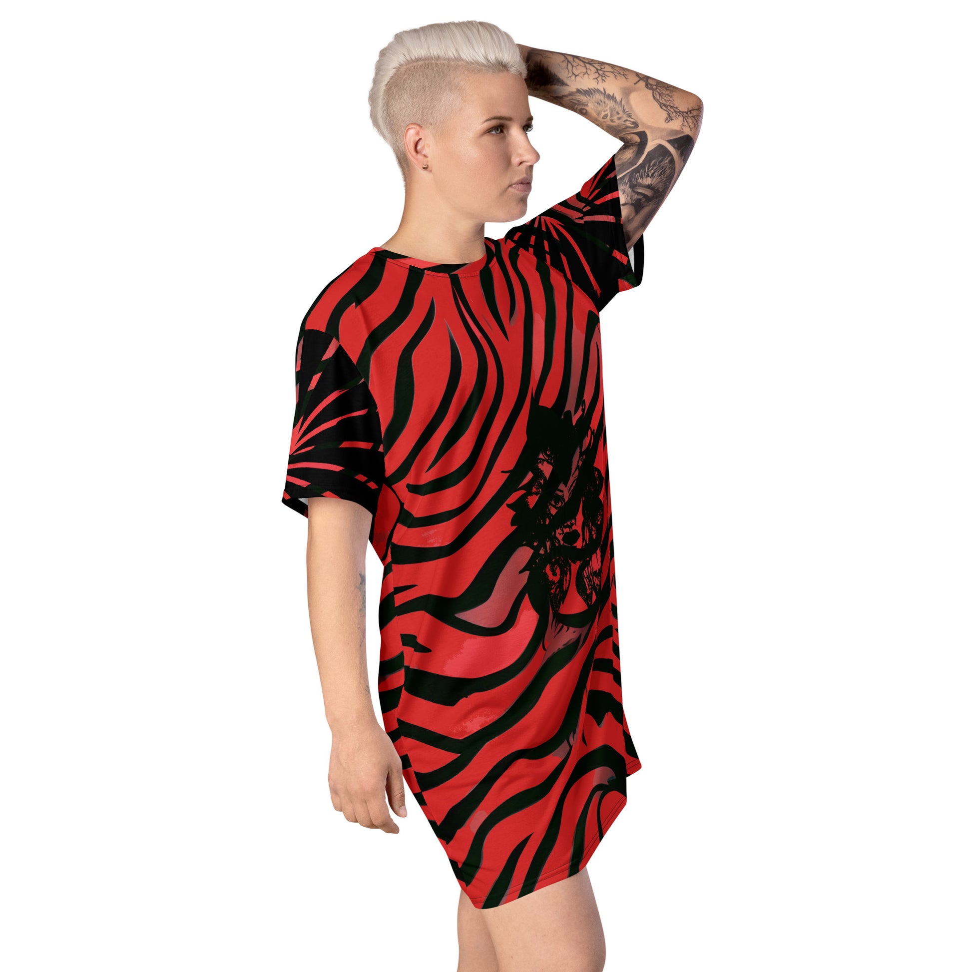 Model wearing a bold red and black t-shirt dress from Kloe Store with an artistic face design, showcasing a stylish and edgy streetwear look with striking patterns and a modern, casual fit.
