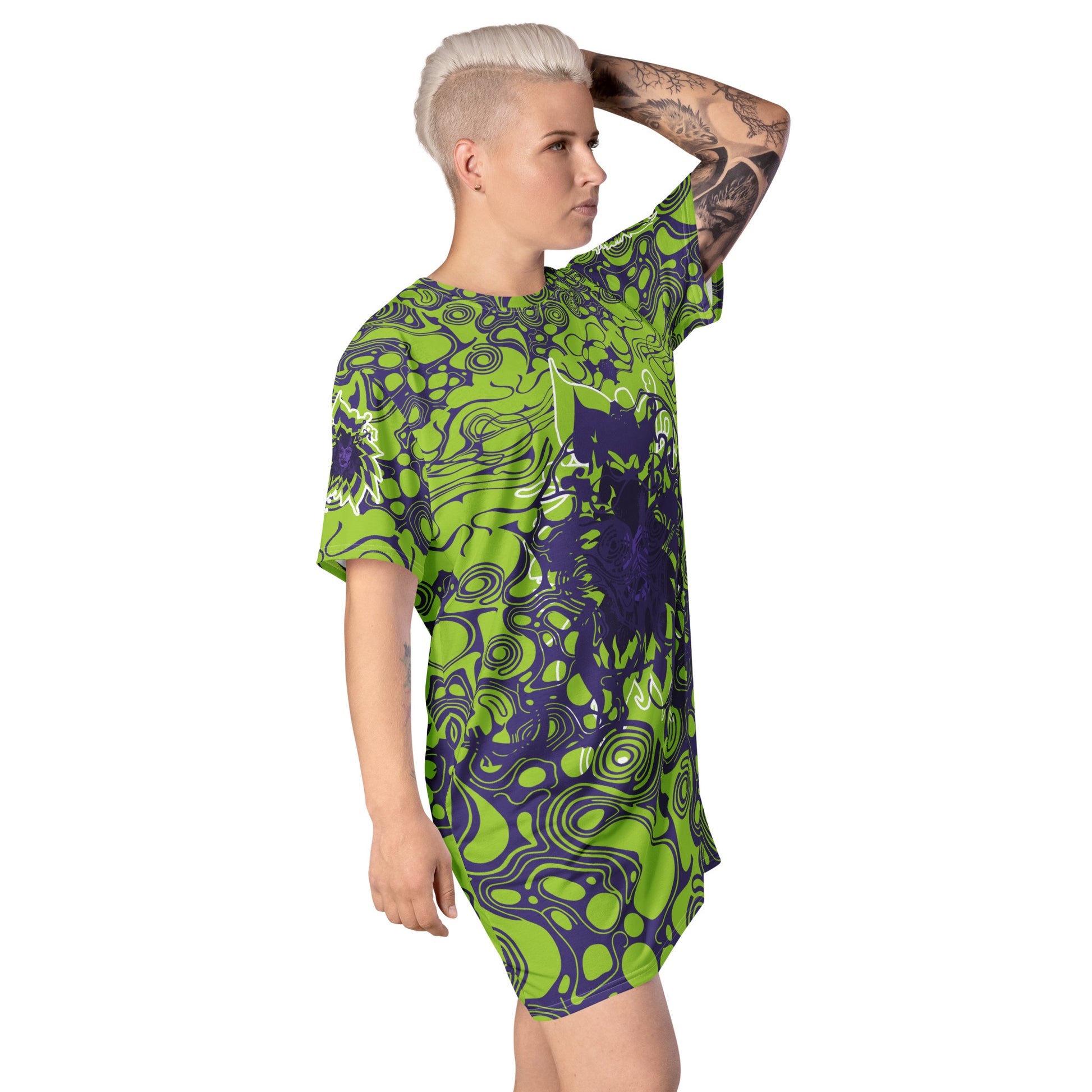 A model wearing green and purple t-shirt dress from Kloe Store featuring bold abstract patterns and a unique central artistic face design, perfect for a trendy and edgy streetwear style.