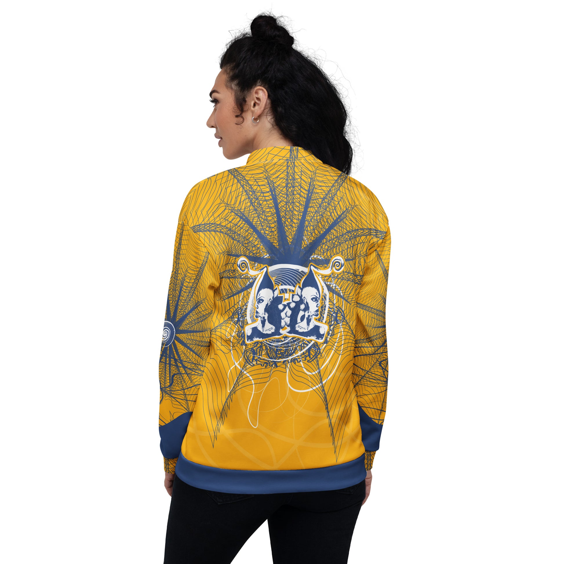 Back view of a golden yellow bomber jacket with intricate navy line art and a mirrored face emblem, combining bold cultural visuals with modern streetwear from the Secret Chambers of I and I collection.