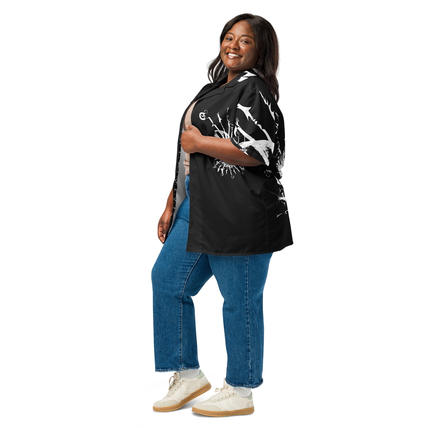 Side view of all-over print unisex button shirt by K.L.O.E featuring white hand-drawn, culturally inspired artwork across the front and sleeves—expressing individuality, transformation, and artistic symbolism through abstract design.