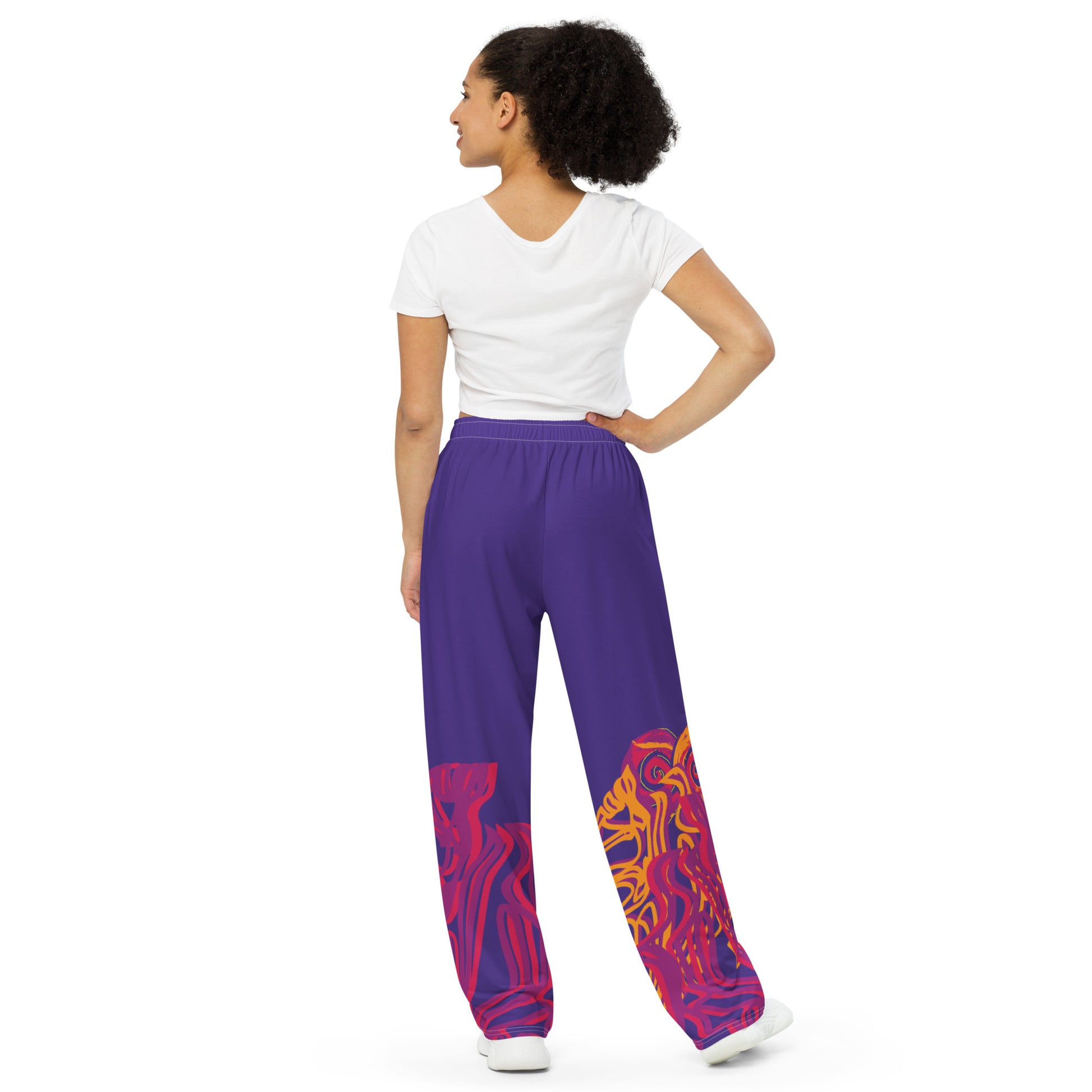 Bold purple wide-leg pants with vibrant orange and red culturally inspired patterns, featuring abstract swirling designs — expressive fashion from KLOE’s The Secret Chambers of I & I collection, on a model.